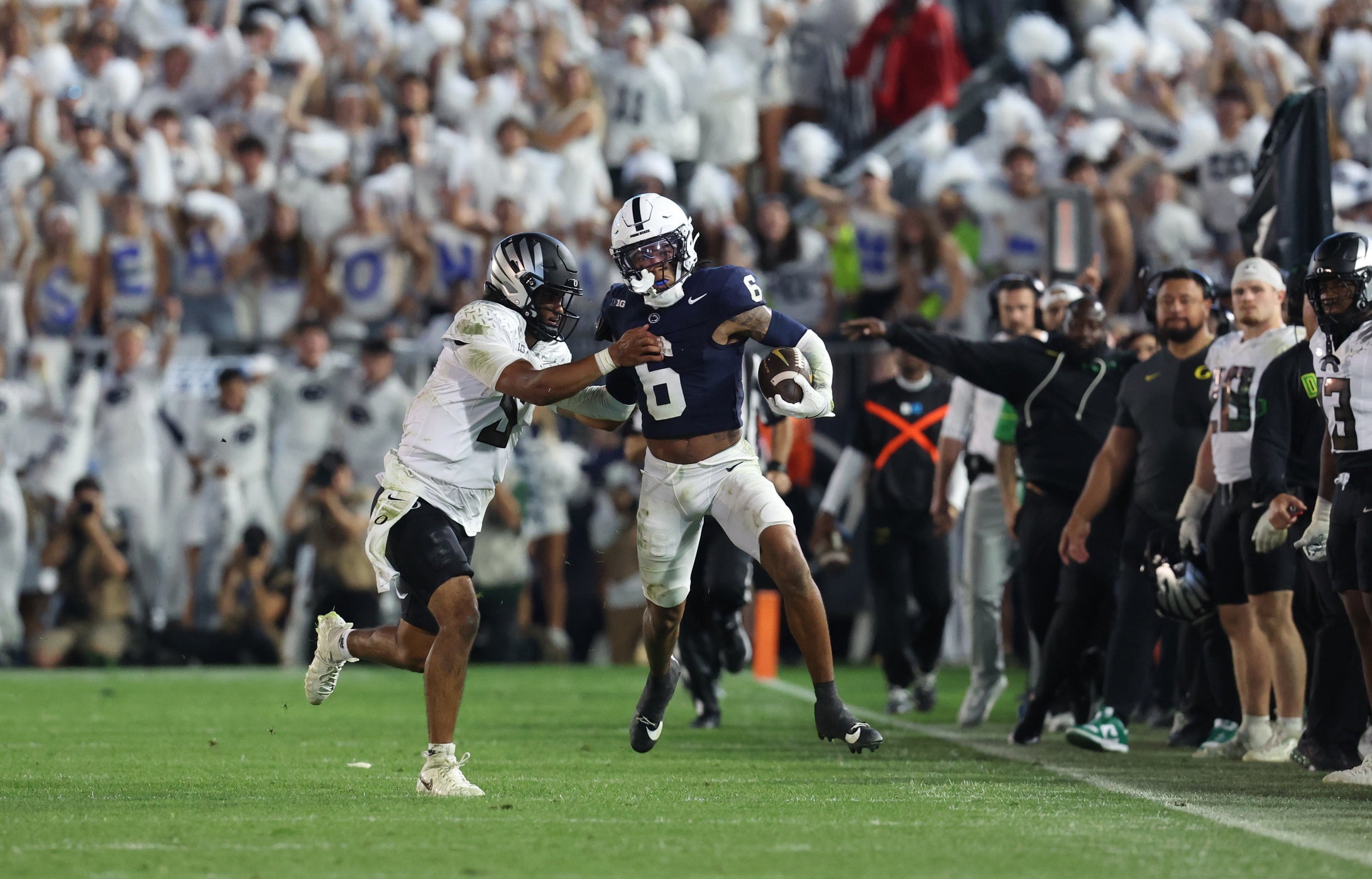 Sep 27, 2025; University Park, Pennsylvania, USA; Penn State Nittany Lions safety Zakee Wheatley (6) runs for a gain before being pushed out of bounds by Oregon Ducks quarterback Dante Moore (5) in a play that was overturned by video review during the third quarter at Beaver Stadium.