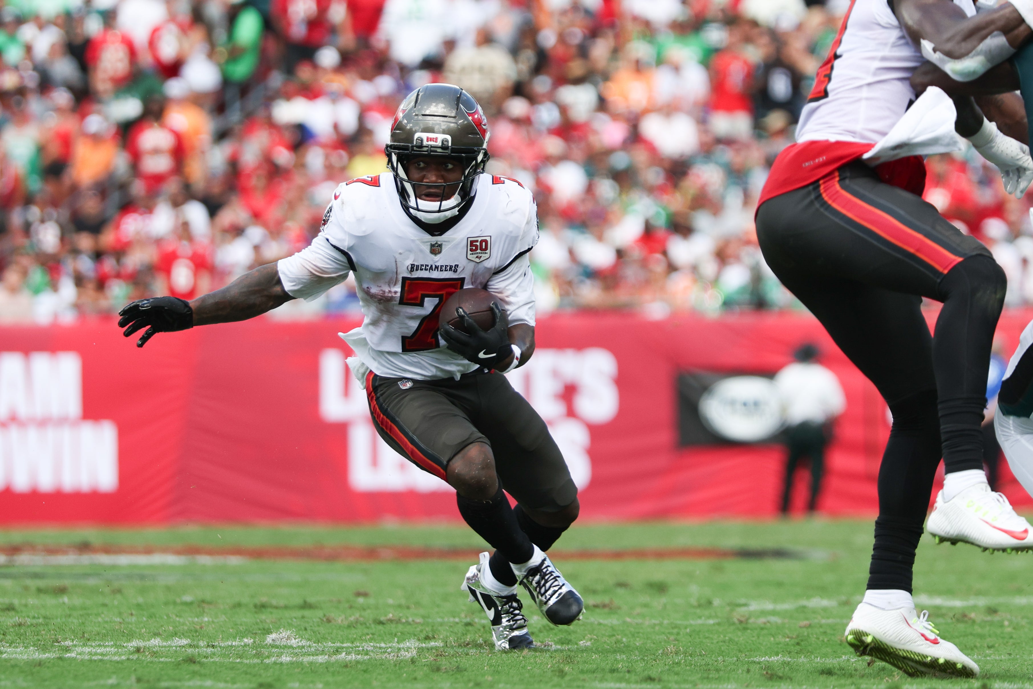 Sep 28, 2025; Tampa, Florida, USA; Tampa Bay Buccaneers running back Bucky Irving (7) runs the ball during the first quarter against the Philadelphia Eagles at Raymond James Stadium.