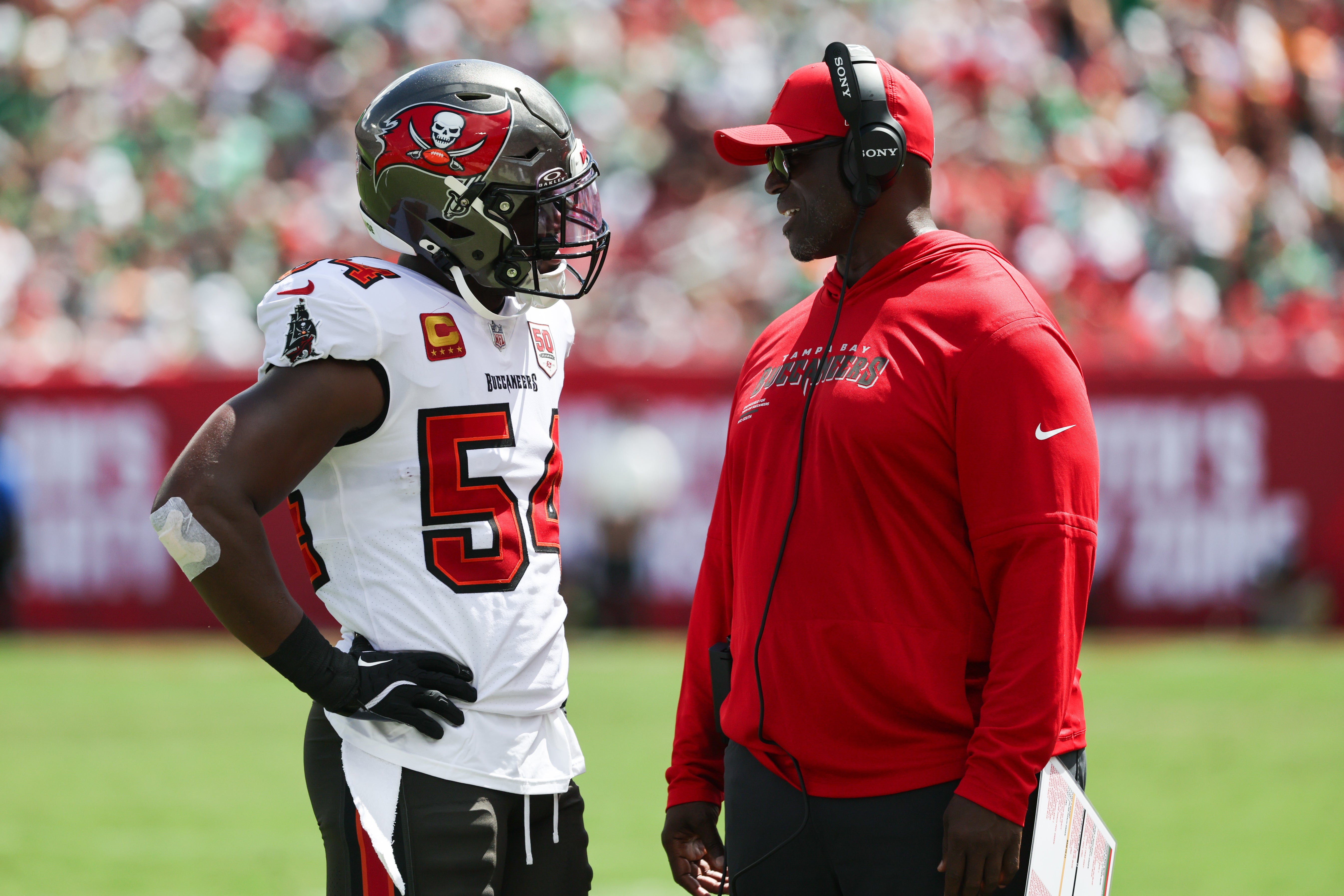 Sep 28, 2025; Tampa, Florida, USA; Tampa Bay Buccaneers outside linebacker Lavonte David (54) speaks with head coach Todd Bowles during the second quarter at Raymond James Stadium.