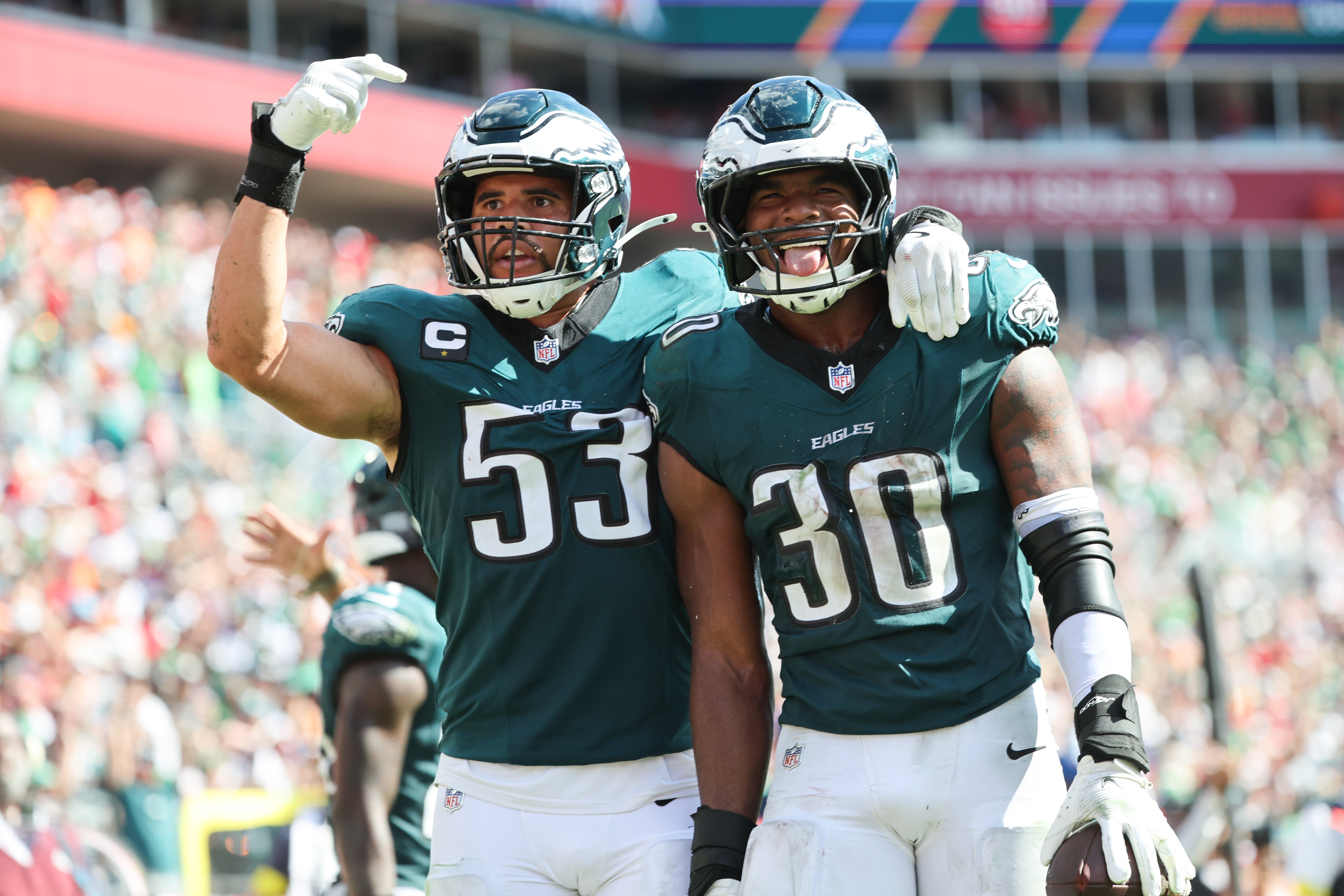 Philadelphia Eagles linebacker Jihaad Campbell (30) celebrates an interception with linebacker Zack Baun (53) during the second half against the Tampa Bay Buccaneers at Raymond James Stadium.
