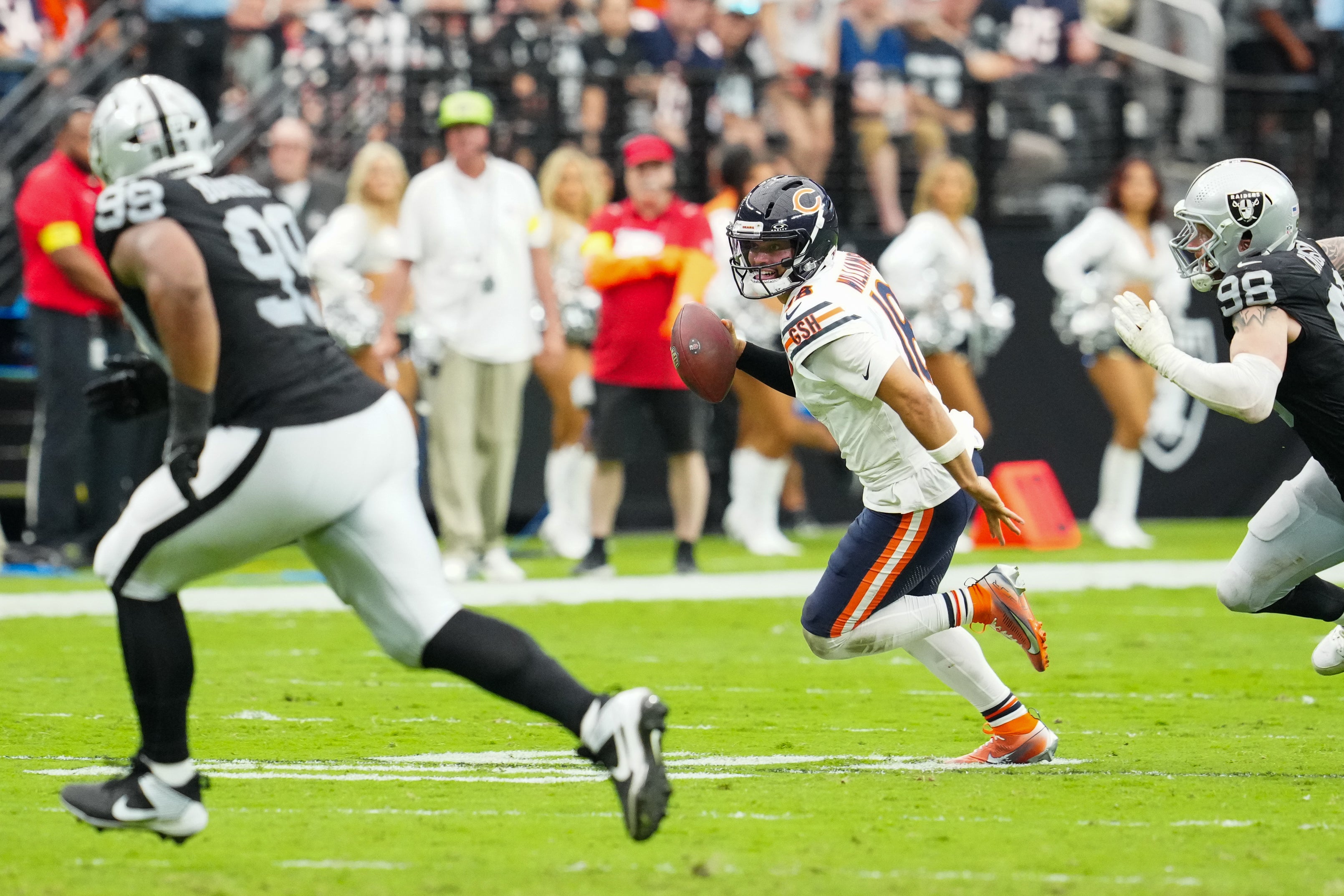 Sep 28, 2025; Paradise, Nevada, USA; Chicago Bears quarterback Caleb Williams (18) rolls out of the pocket during the second quarter against the Las Vegas Raiders at Allegiant Stadium.