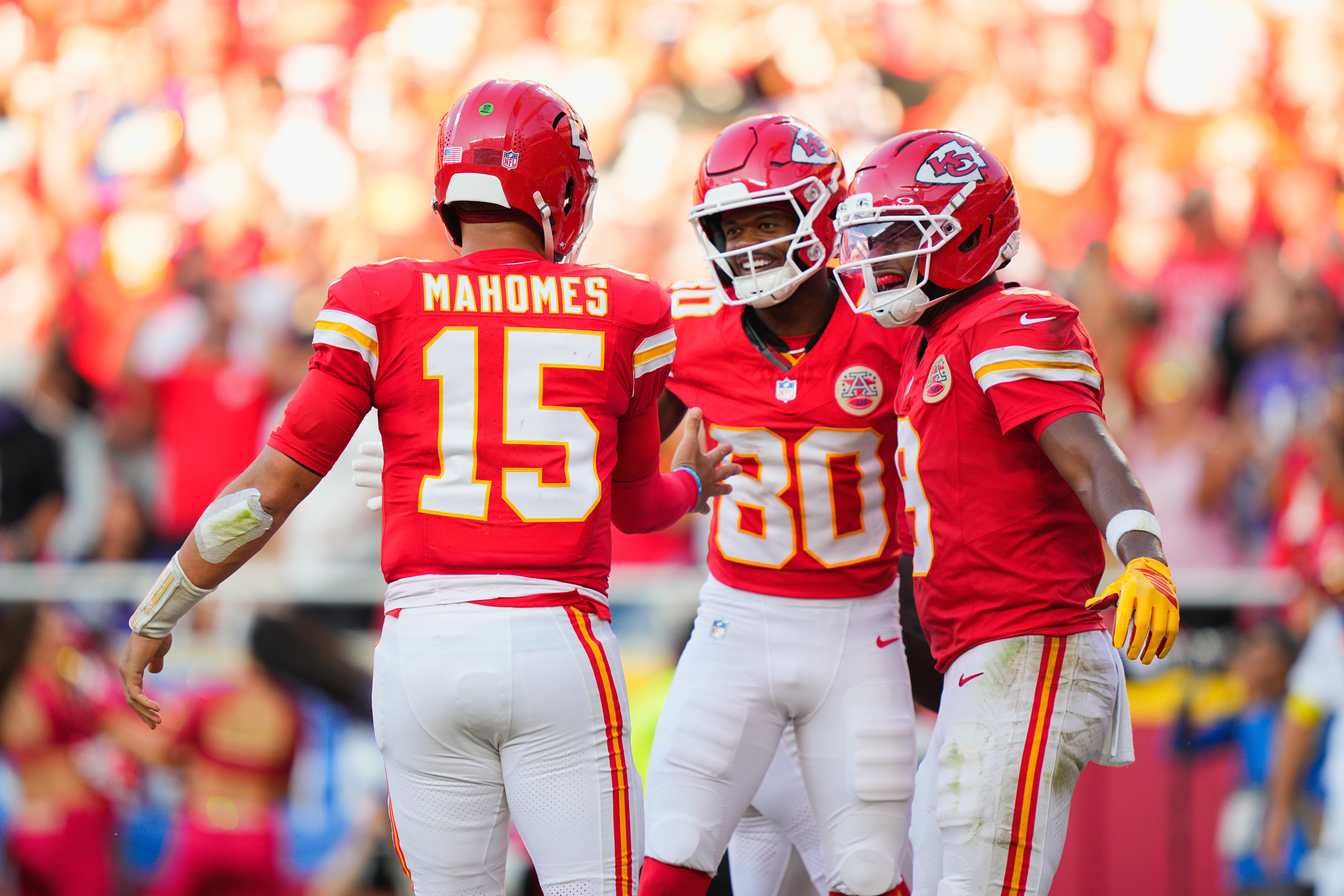 Kansas City Chiefs wide receiver Tyquan Thornton (80) celebrates with quarterback Patrick Mahomes (15) and wide receiver JuJu Smith-Schuster (9) after scoring a touchdown during the third quarter at GEHA Field at Arrowhead Stadium.