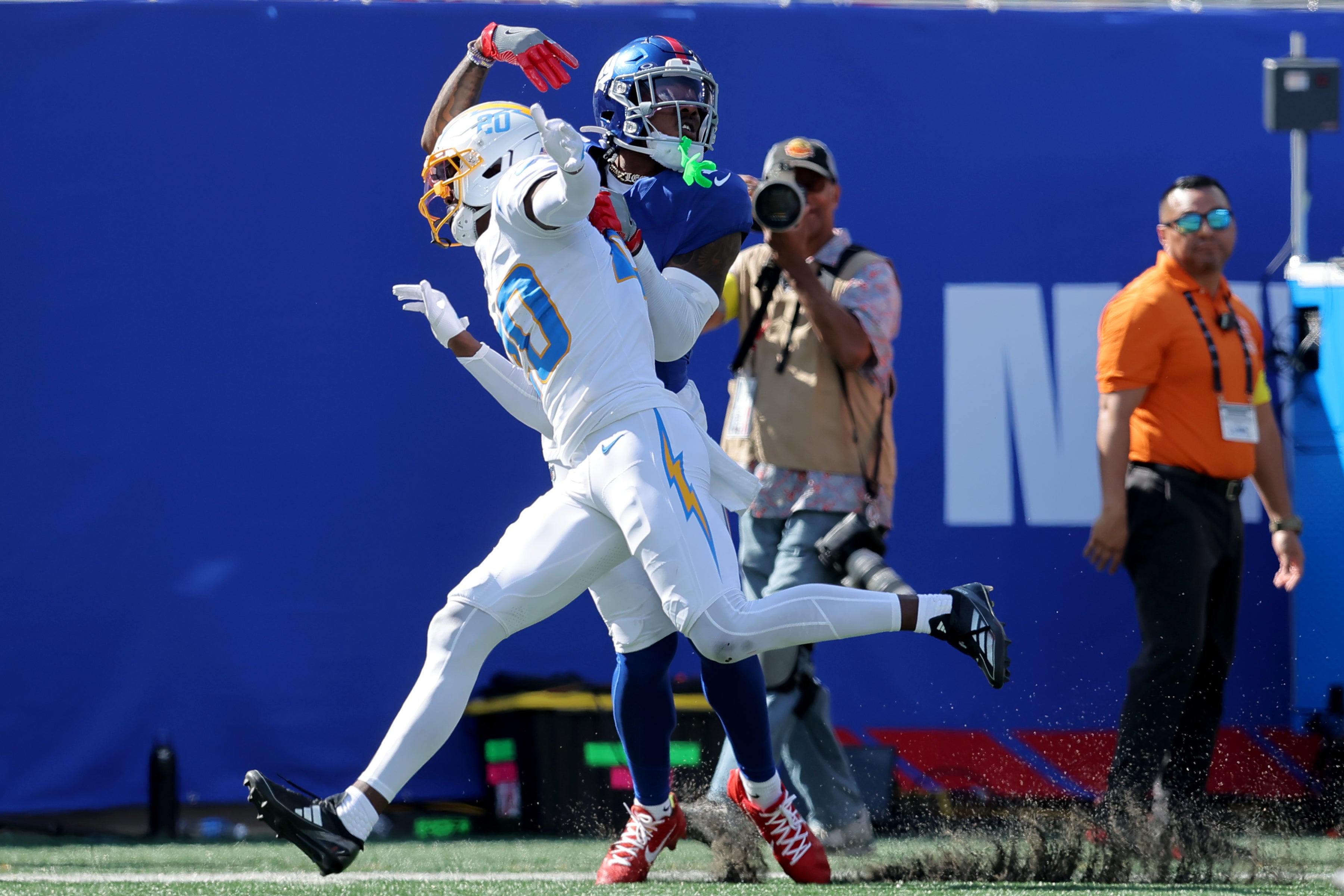 Sep 28, 2025; East Rutherford, New Jersey, USA; Los Angeles Chargers cornerback Cam Hart (20) breaks up a pass intended for New York Giants wide receiver Malik Nabers (1) during the second quarter at MetLife Stadium. Nabers was carted off the field with an injury after the play.