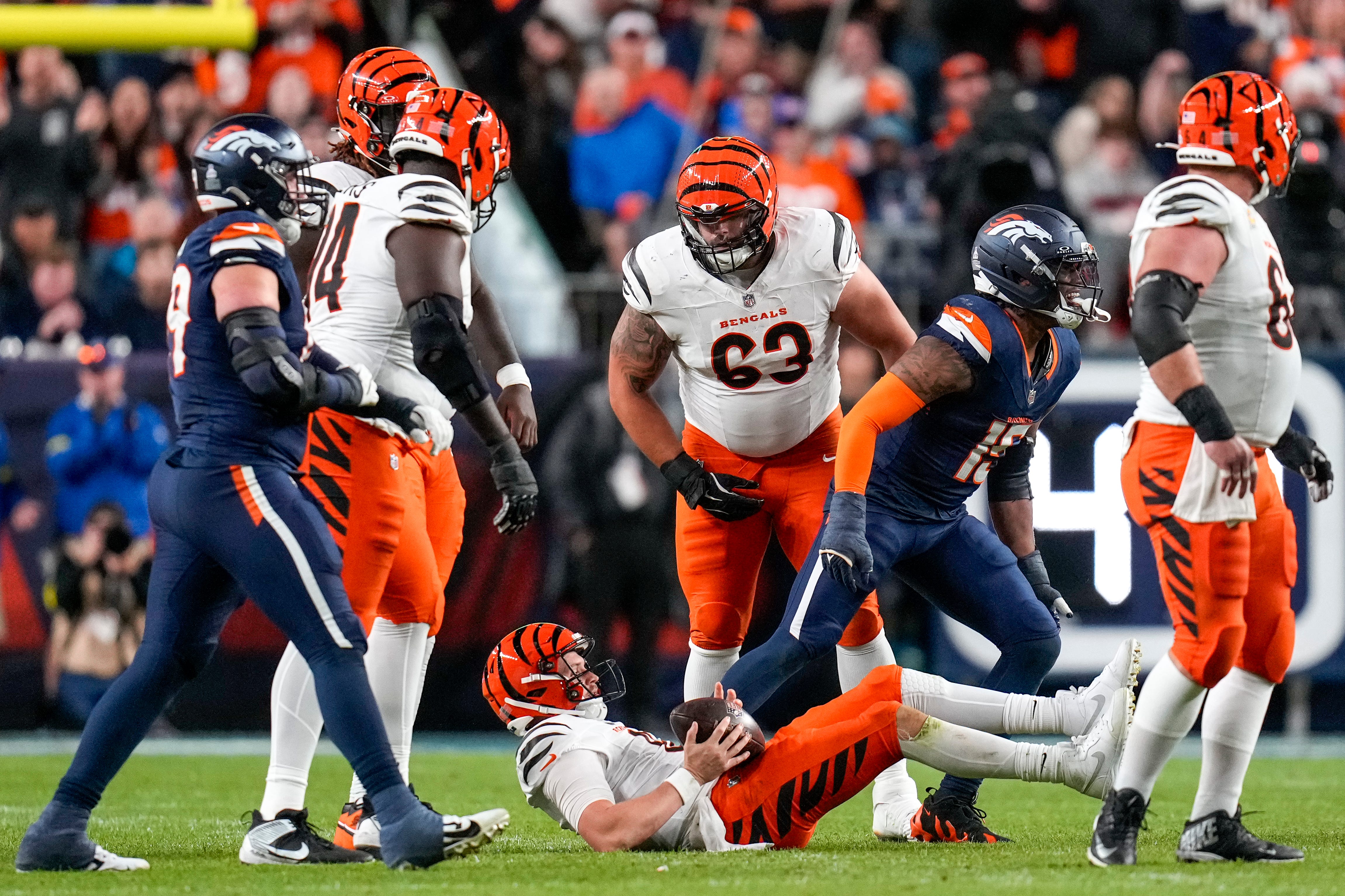 Cincinnati Bengals quarterback Jake Browning (6) is taken to the ground in the third quarter of the NFL Week 4 Monday Night Football game between the Denver Broncos and the Cincinnati Bengals at Empower Field at Mile High in Denver on Monday, Sept. 29, 2025. The Bengals fell to 2-2 with a 28-3 loss to the Broncos.