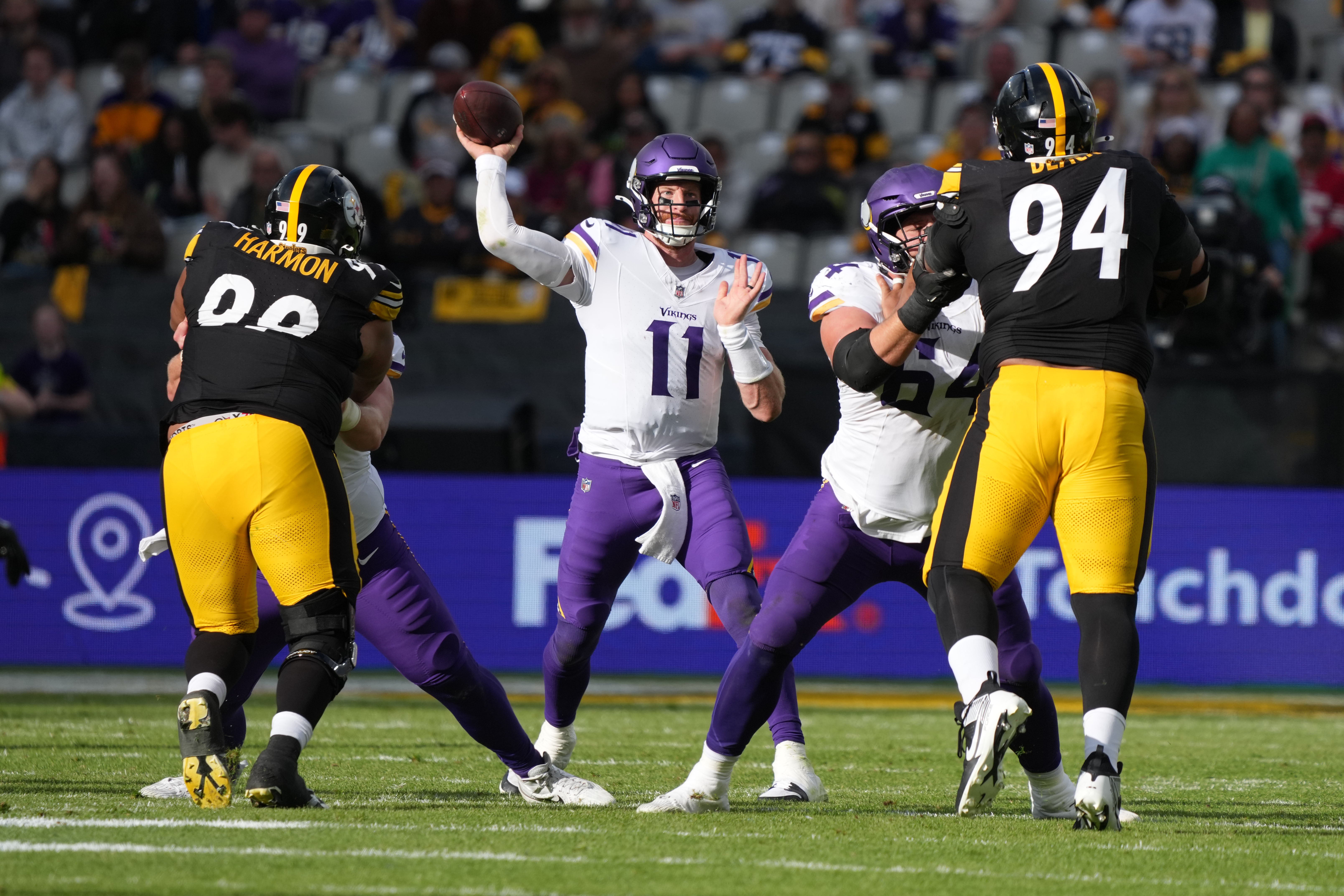 Sep 28, 2025; Dublin, Ireland; Minnesota Vikings quarterback Carson Wentz (11) throws the ball against Pittsburgh Steelers defensive end Demarvin Leal (98) and defensive tackle Yahya Black (94) during an NFL International Series game at Croke Park.