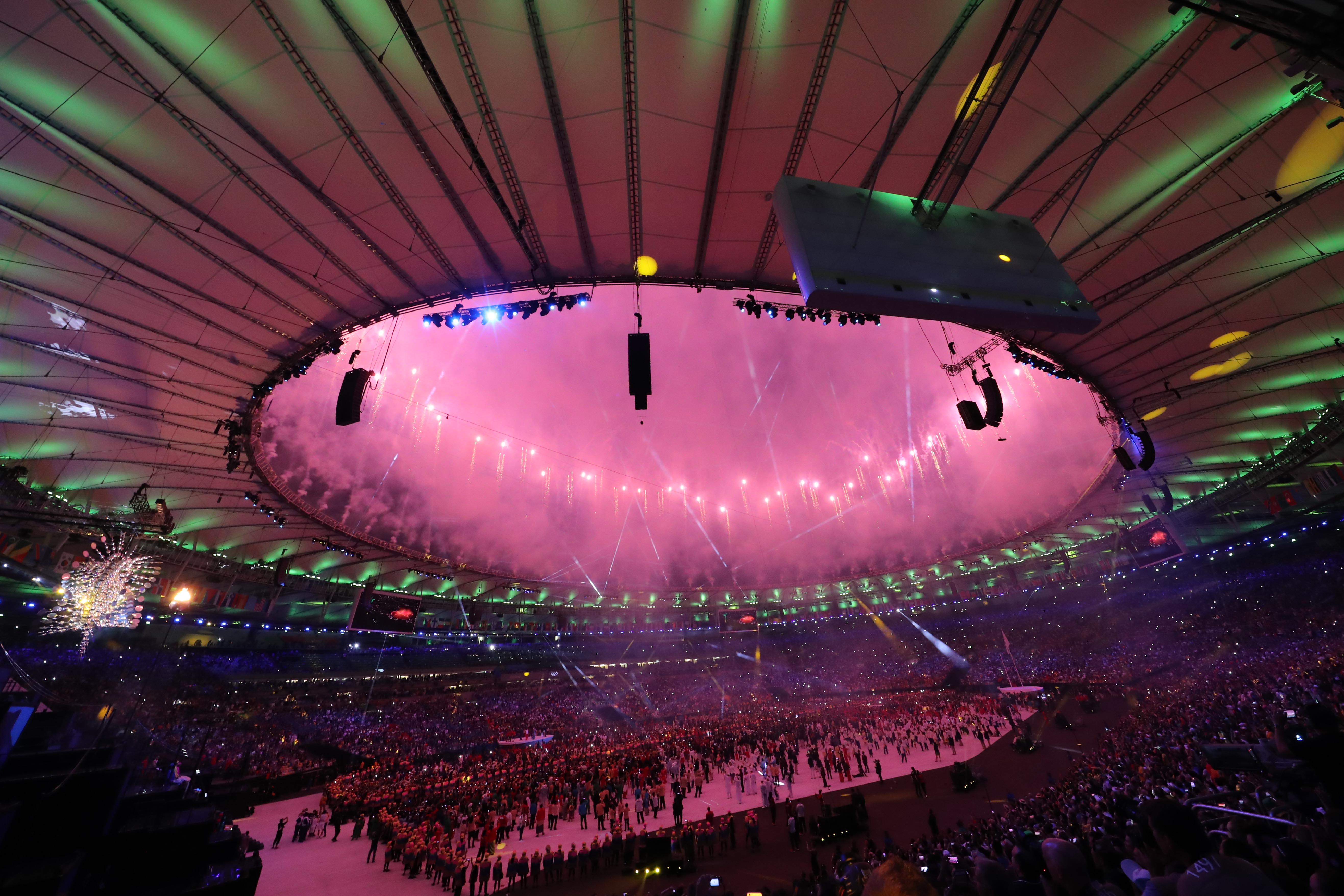 Aug 5, 2016; Rio de Janeiro, Brazil; Fireworks explode as the Olympic Cauldron burns at lower left during the opening ceremonies of the Rio 2016 Summer Olympic Games at Maracana.