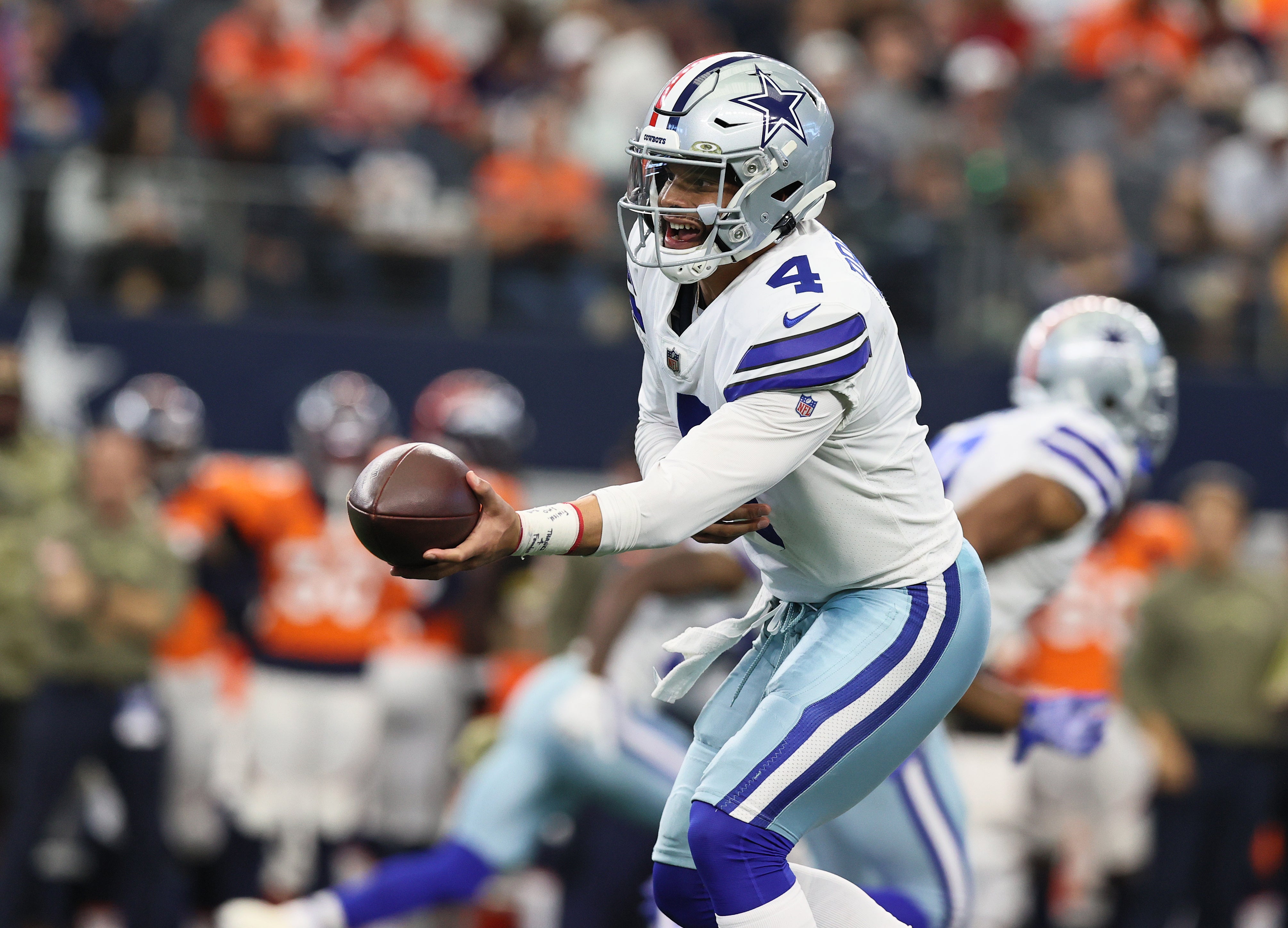 Nov 7, 2021; Arlington, Texas, USA; Dallas Cowboys quarterback Dak Prescott (4) hands off the ball against the Denver Broncos at AT&T Stadium.