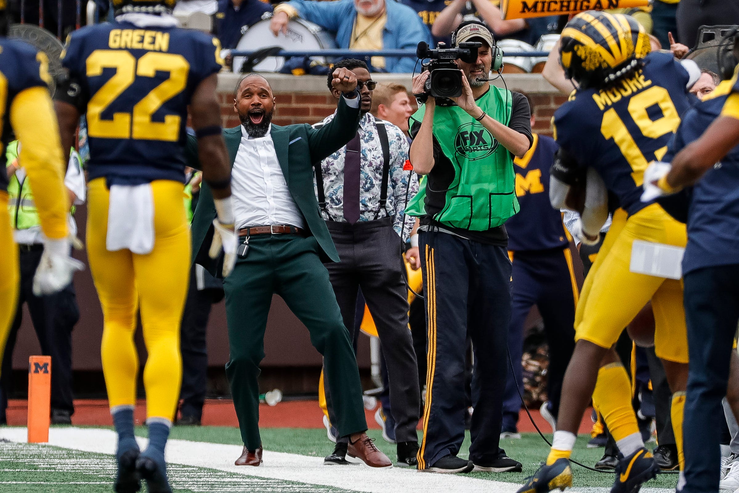 Charles Woodson, center, celebrates an interception made by Michigan defensive back R.J. Moten (6) against Maryland during the second half at the Michigan Stadium in Ann Arbor on Saturday, Sept. 24, 2022.
