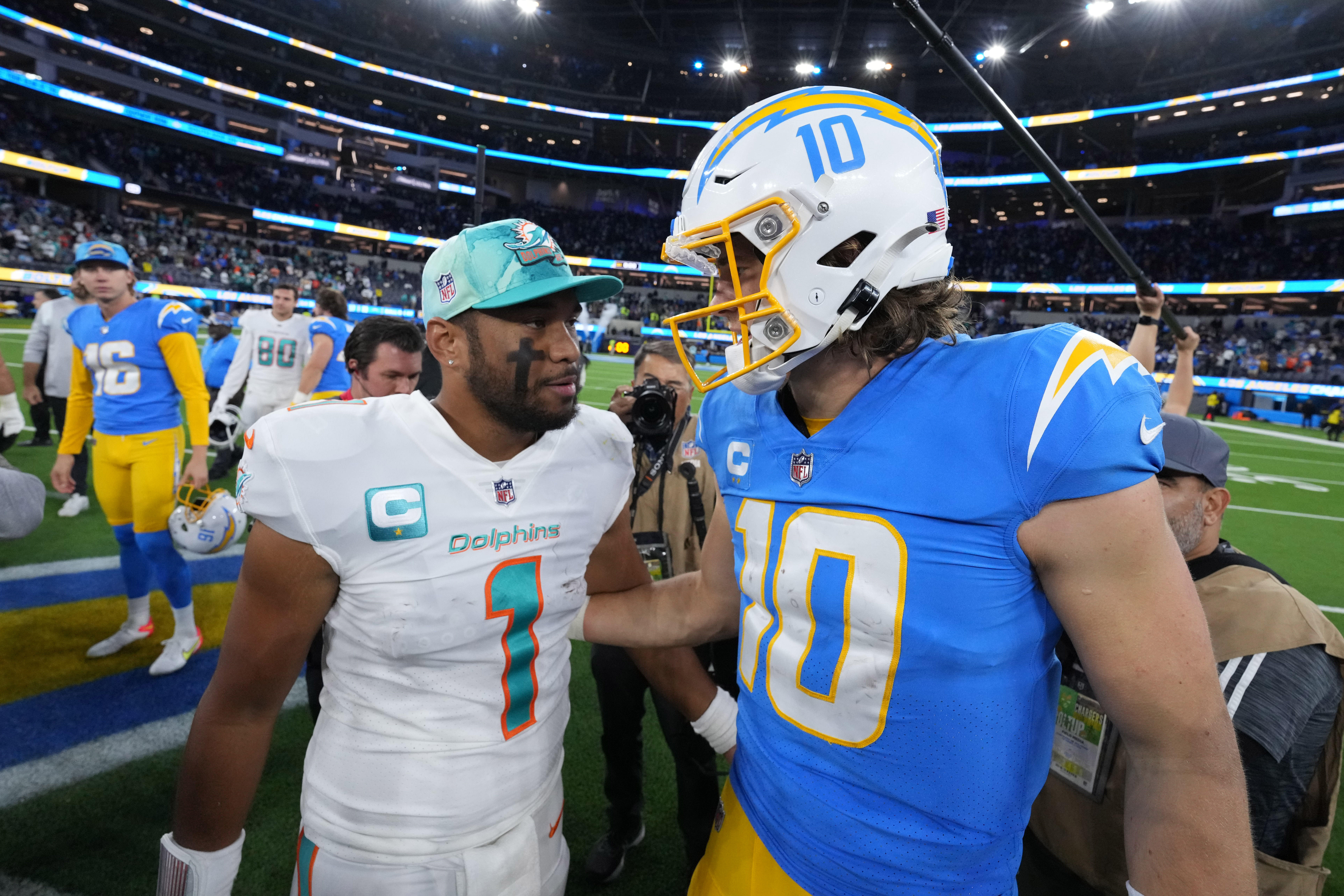 Dec 11, 2022; Inglewood, California, USA; Miami Dolphins quarterback Tua Tagovailoa (1) and Los Angeles Chargers quarterback Justin Herbert (10) shake hands after the game at SoFi Stadium. Mandatory Credit: Kirby Lee-USA TODAY Sports
