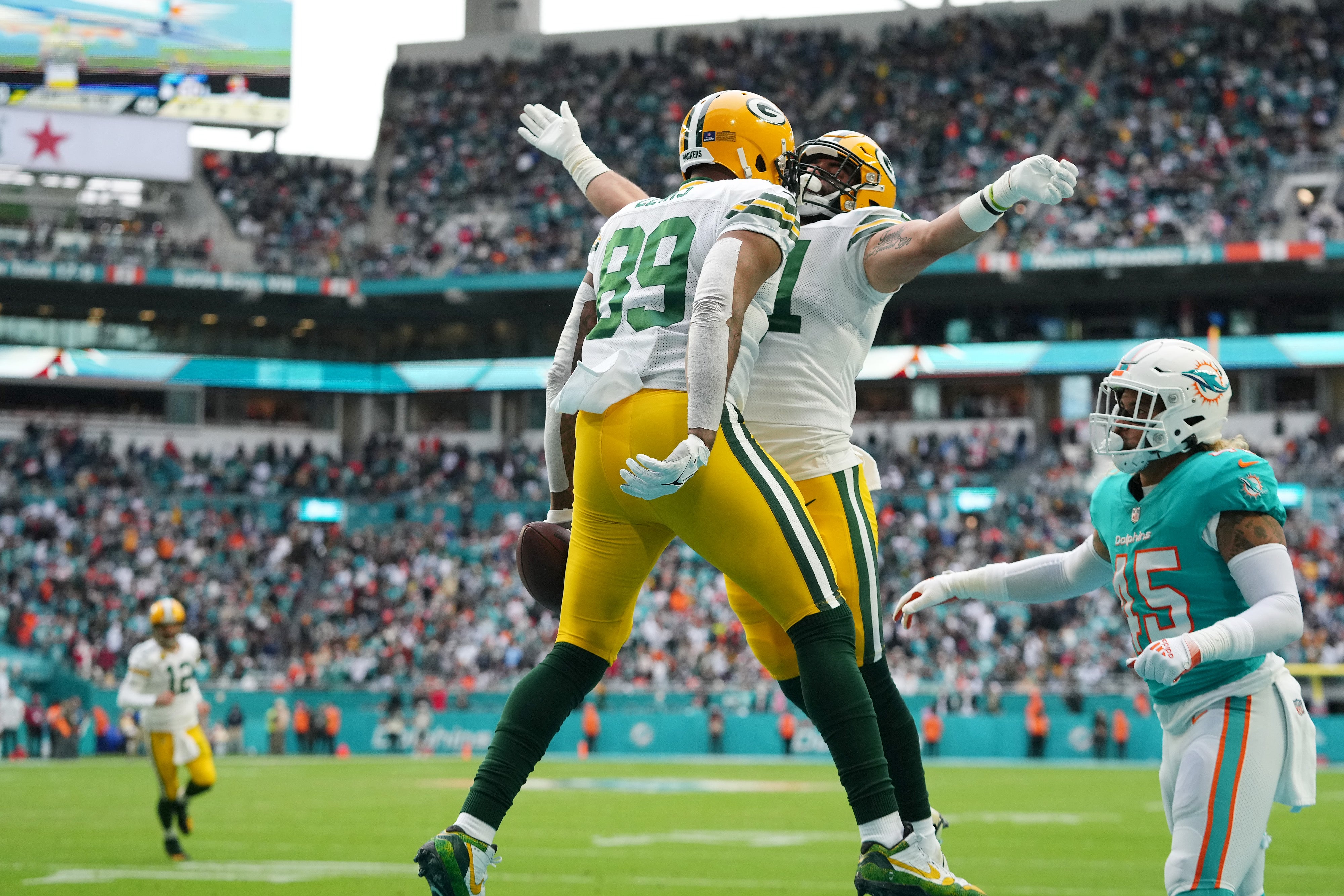 Dec 25, 2022; Miami Gardens, Florida, USA; Green Bay Packers tight end Marcedes Lewis (89) celebrates his touchdown against the Miami Dolphins with tight end Josiah Deguara (81) during the first half at Hard Rock Stadium.
