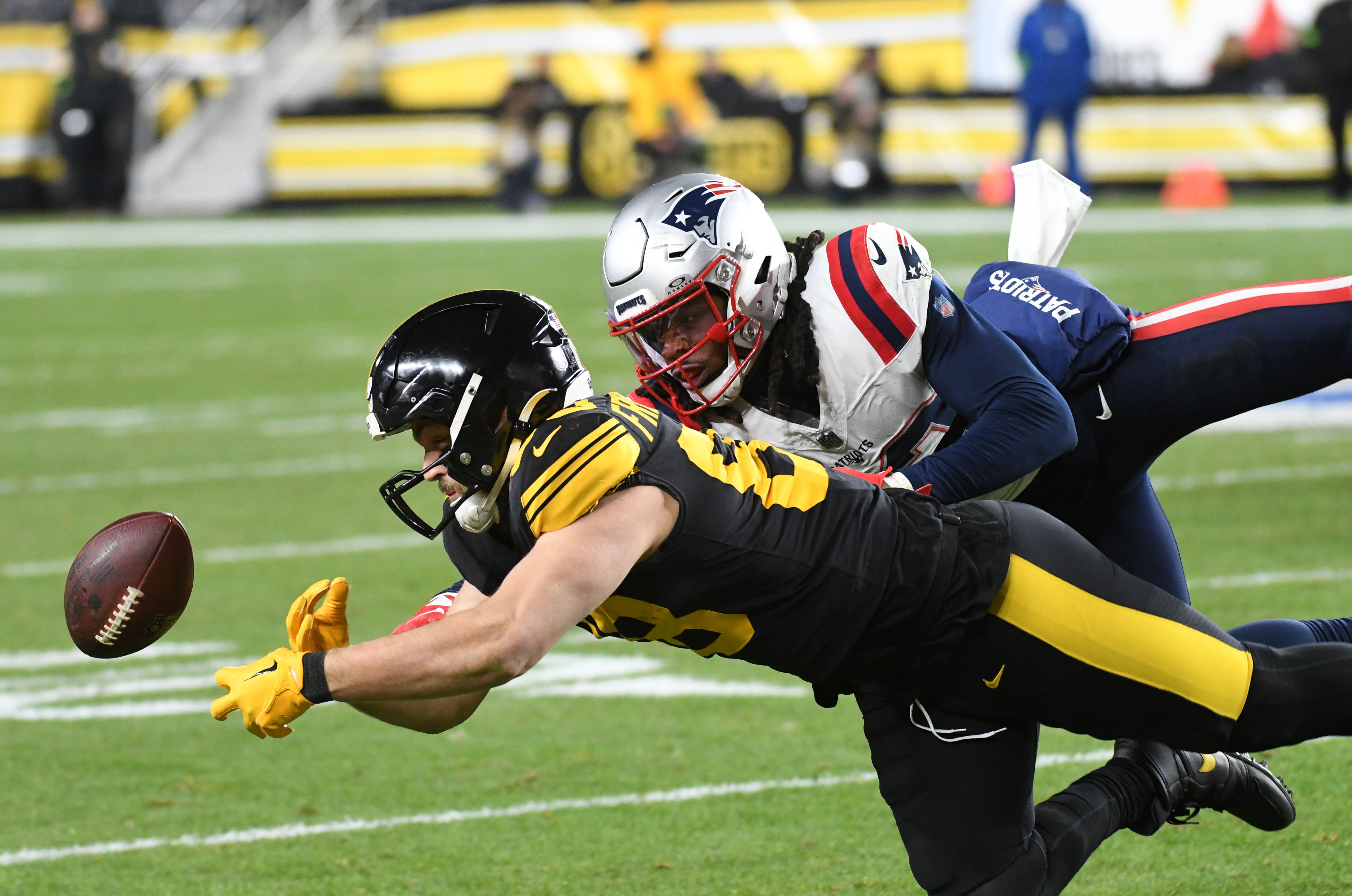Dec 7, 2023; Pittsburgh, Pennsylvania, USA; Pittsburgh Steelers tight end Pat Freiermuth (88) drops the ball as New England Patriots defensive back Kyle Dugger (23) is called for pass interference during the second quarter at Acrisure Stadium.