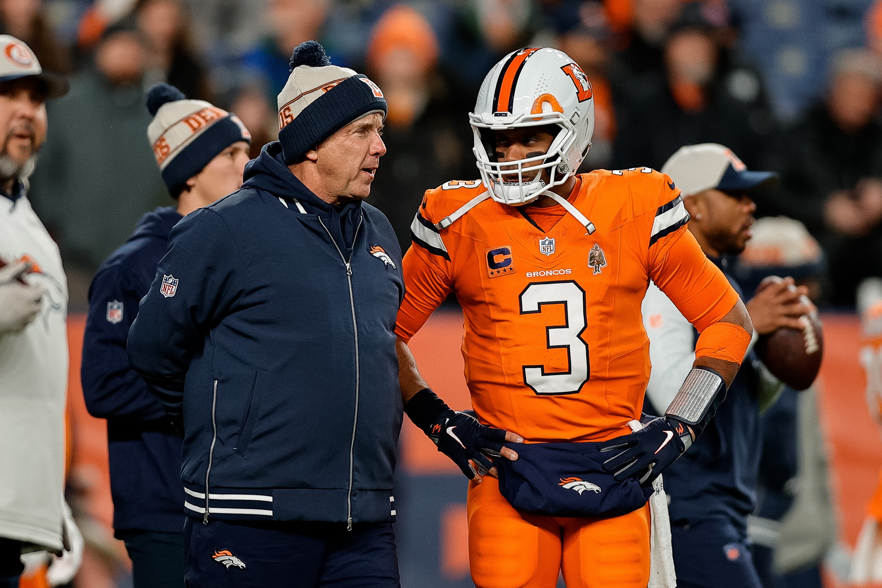 Dec 24, 2023; Denver, Colorado, USA; Denver Broncos head coach Sean Payton talks with quarterback Russell Wilson (3) before the game against the New England Patriots at Empower Field at Mile High.