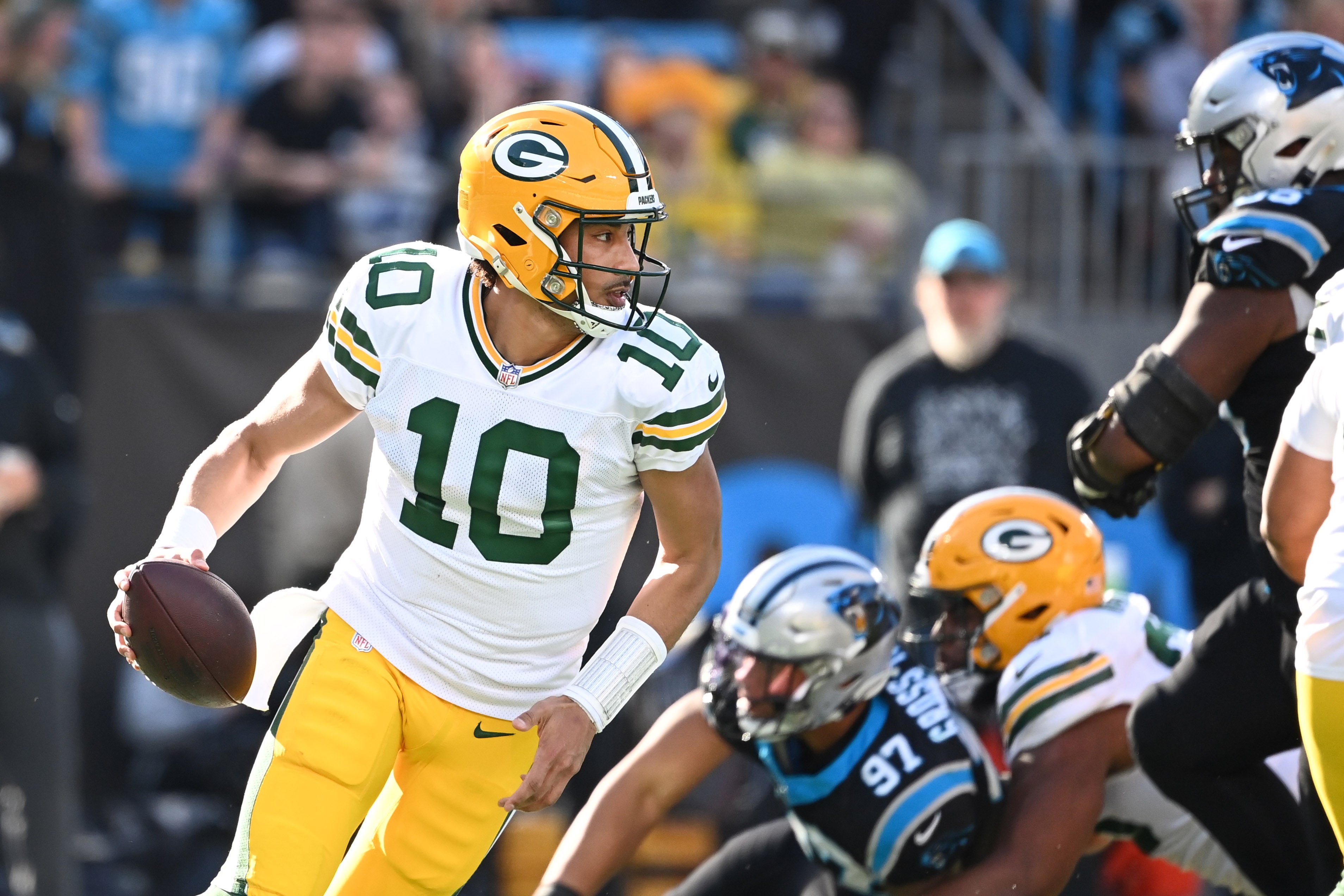 Dec 24, 2023; Charlotte, North Carolina, USA; Green Bay Packers quarterback Jordan Love (10) looks to pass as Carolina Panthers linebacker Yetur Gross-Matos (97) pressures in the second quarter at Bank of America Stadium.