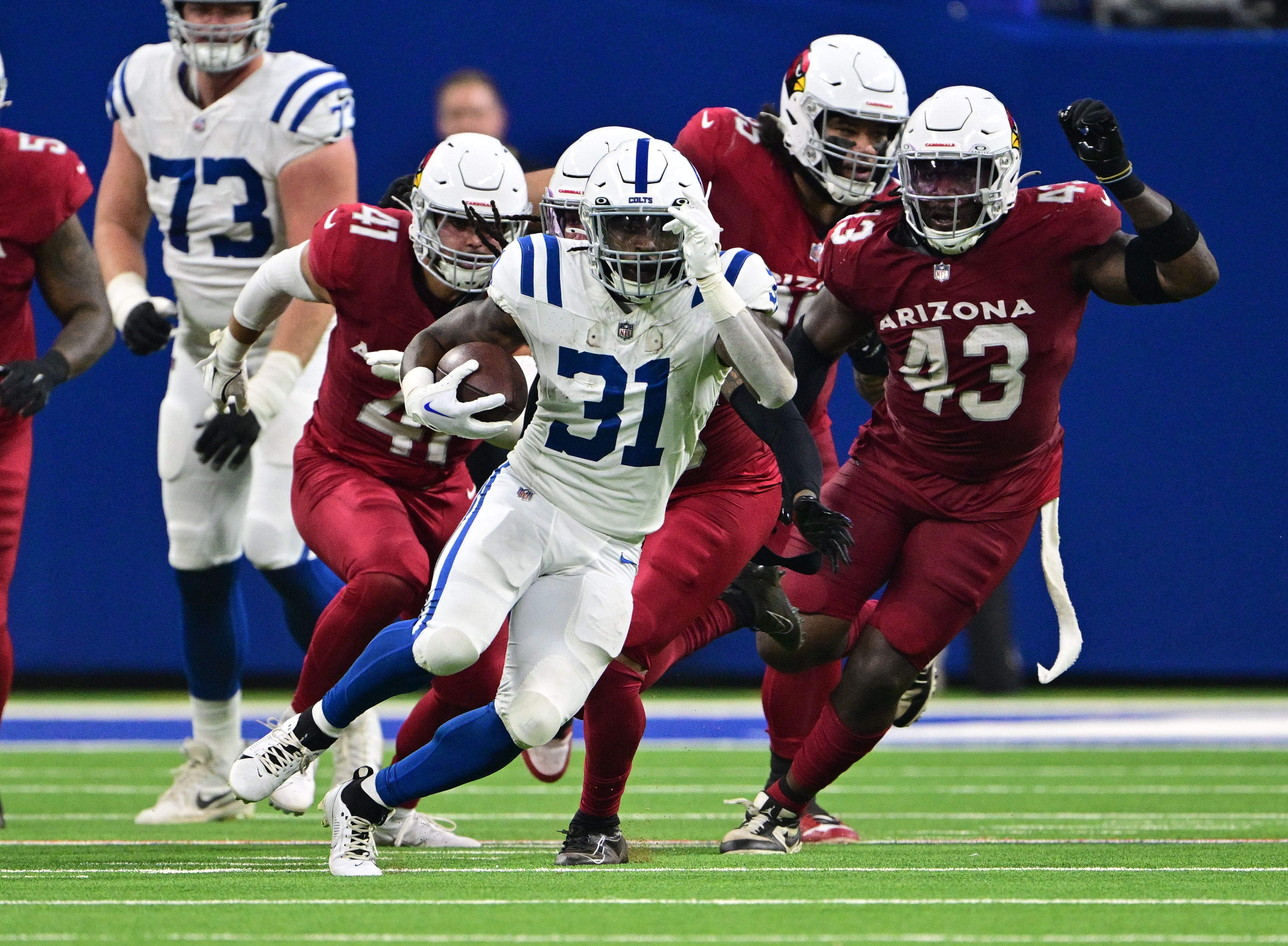 Colts RB Tyler Goodson runs away from Cardinals defenders
