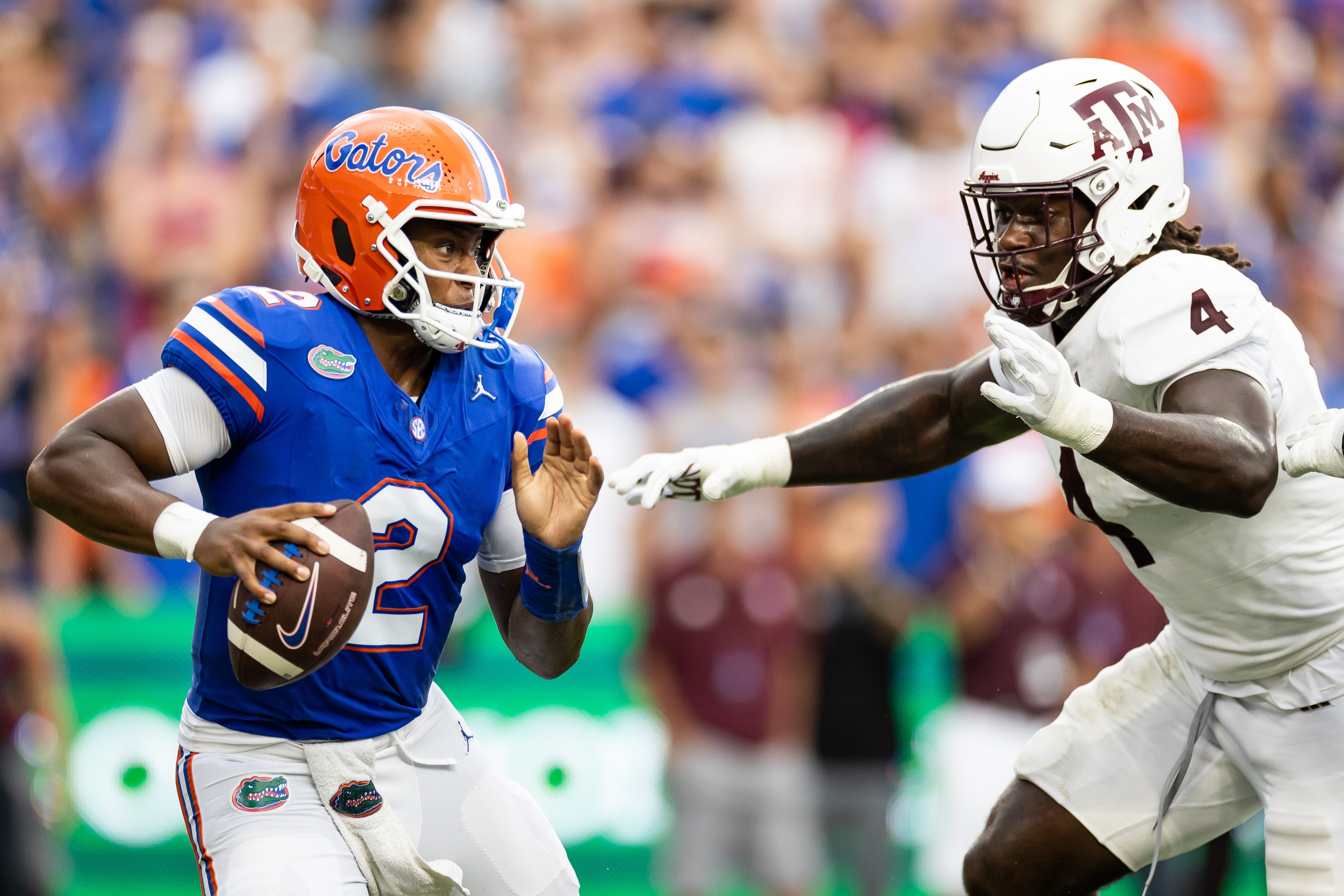 Sep 14, 2024; Gainesville, Florida, USA; Florida Gators quarterback DJ Lagway (2) evades Texas A&M Aggies defensive lineman Shemar Stewart (4) during the first half at Ben Hill Griffin Stadium.