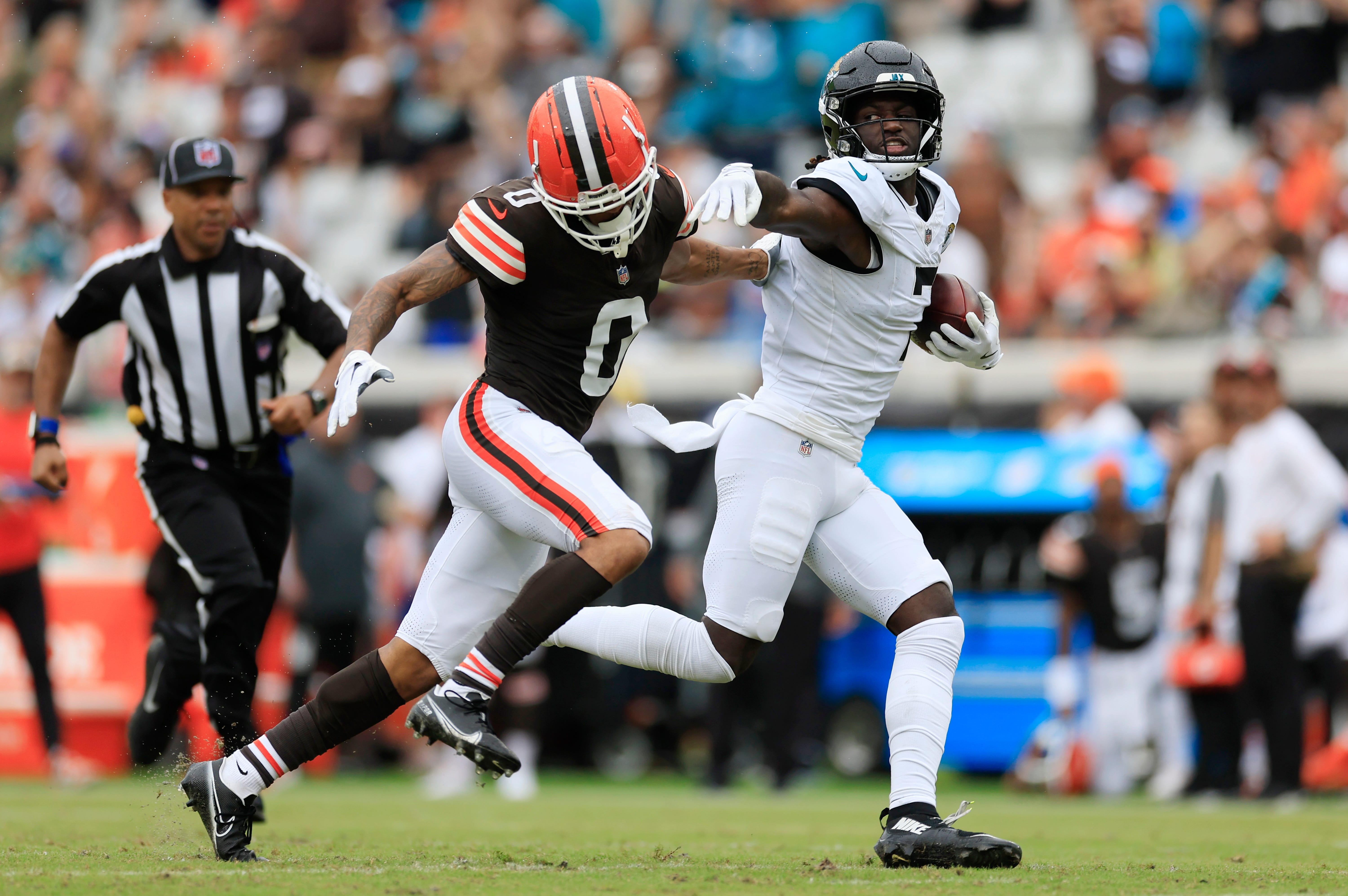 Jacksonville Jaguars wide receiver Brian Thomas Jr. (7) stiff arms Cleveland Browns cornerback Greg Newsome II (0) during the third quarter of an NFL football matchup Sunday, Sept. 15, 2024 at EverBank Stadium in Jacksonville, Fla. The Browns defeated the Jaguars 18-13.