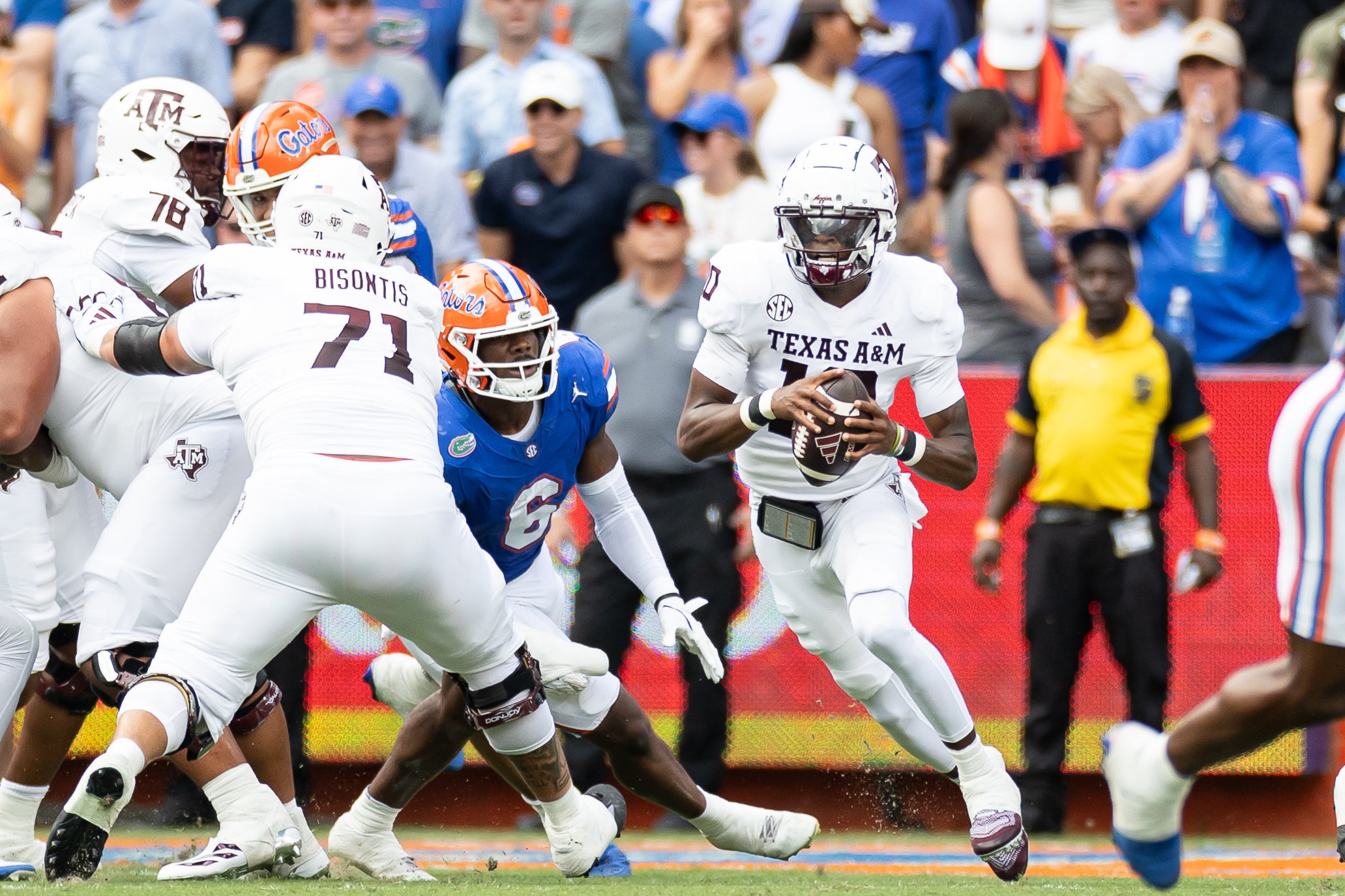 Sep 14, 2024; Gainesville, Florida, USA; Texas A&M Aggies quarterback Marcel Reed (10) scrambles with the ball past Florida Gators linebacker Shemar James (6) during the first half at Ben Hill Griffin Stadium.