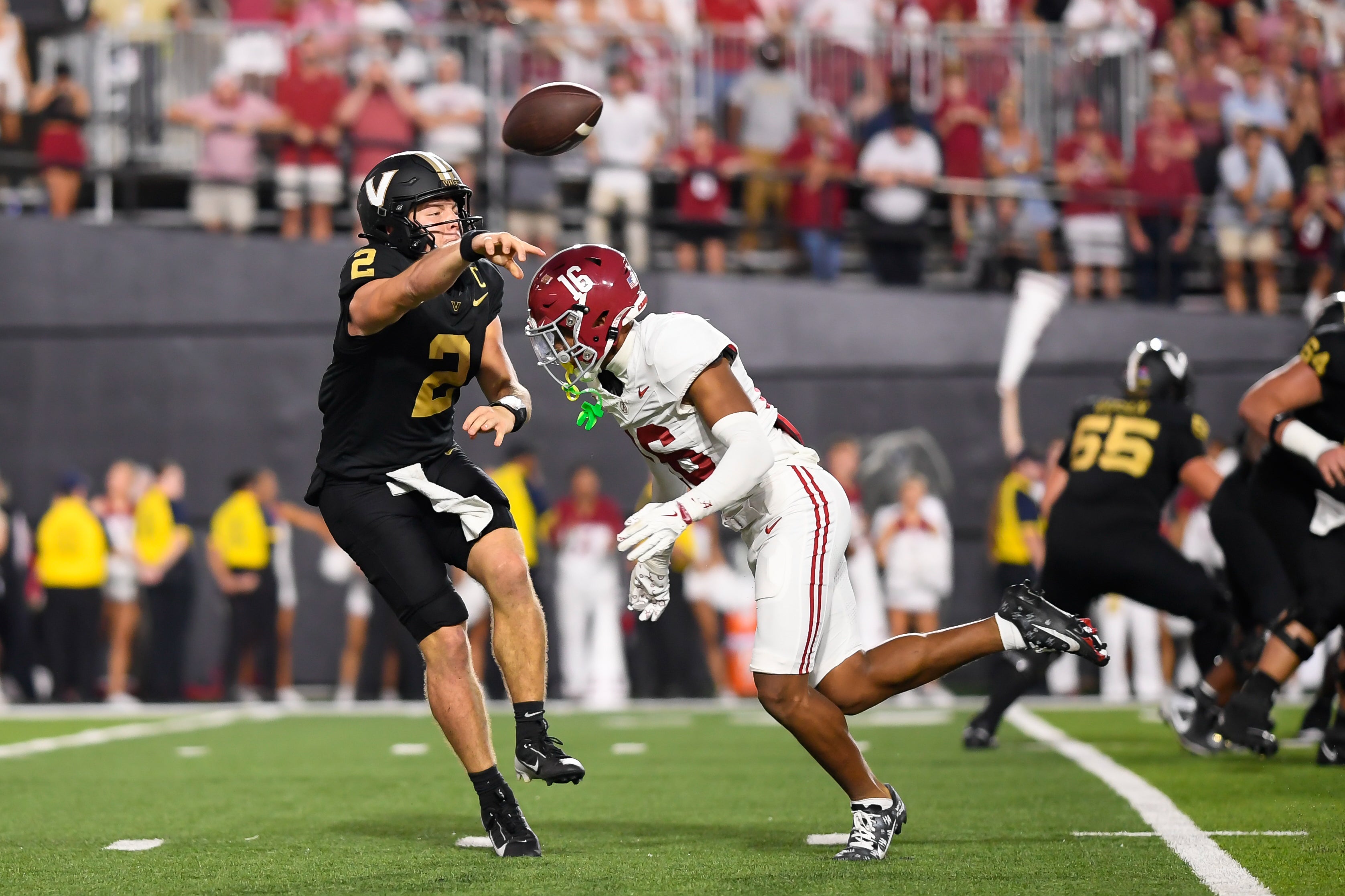 Oct 5, 2024; Nashville, Tennessee, USA; Vanderbilt Commodores quarterback Diego Pavia (2) scrambles as Alabama Crimson Tide defensive back Red Morgan (16) bears down on him during the second half at FirstBank Stadium.