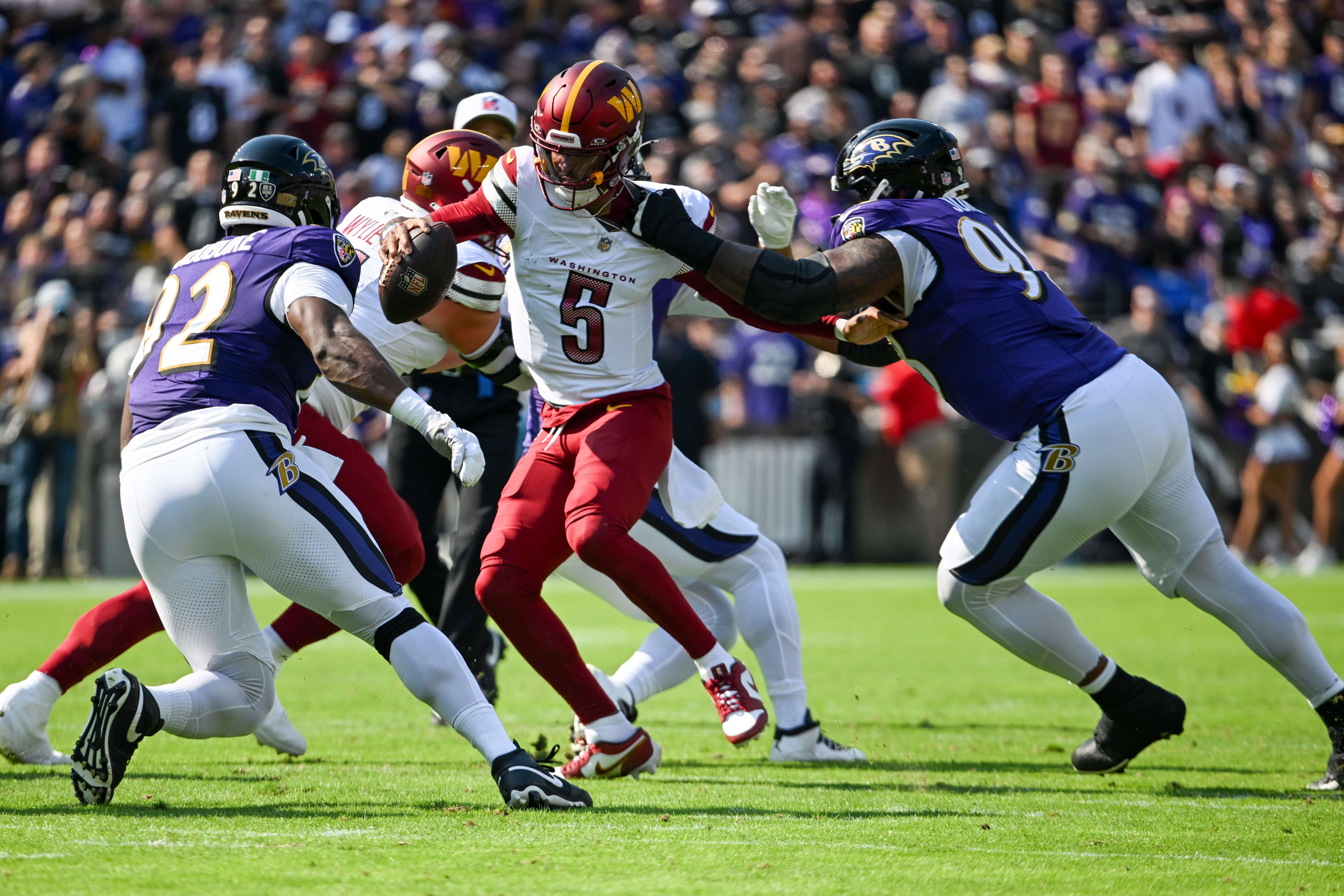 Oct 13, 2024; Baltimore, Maryland, USA; Baltimore Ravens defensive tackle Travis Jones (98) sacks Washington Commanders quarterback Jayden Daniels (5) during the first quarter at M&T Bank Stadium.