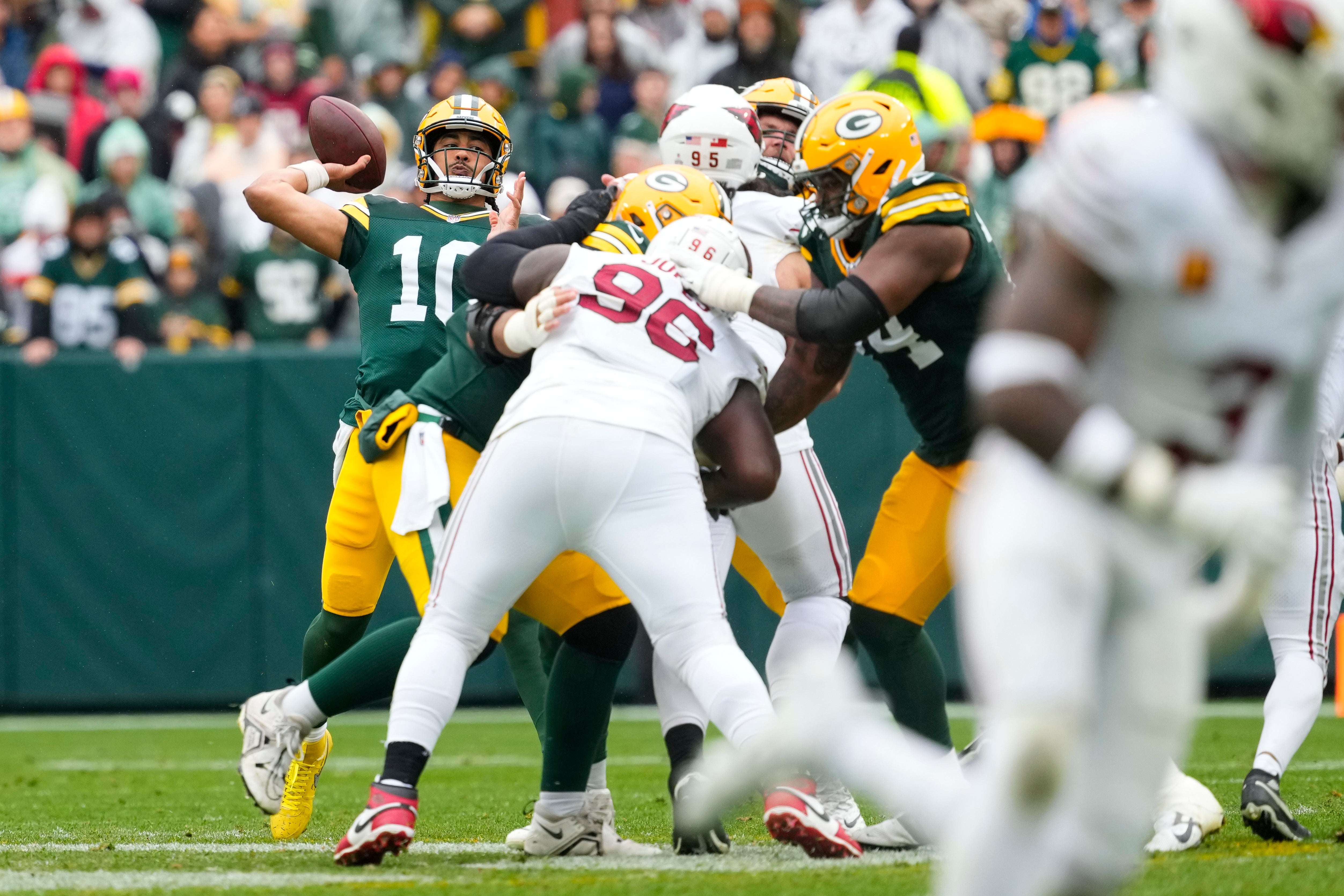 Oct 13, 2024; Green Bay, Wisconsin, USA; Green Bay Packers quarterback Jordan Love (10) throws a pass during the second quarter against the Arizona Cardinals at Lambeau Field.