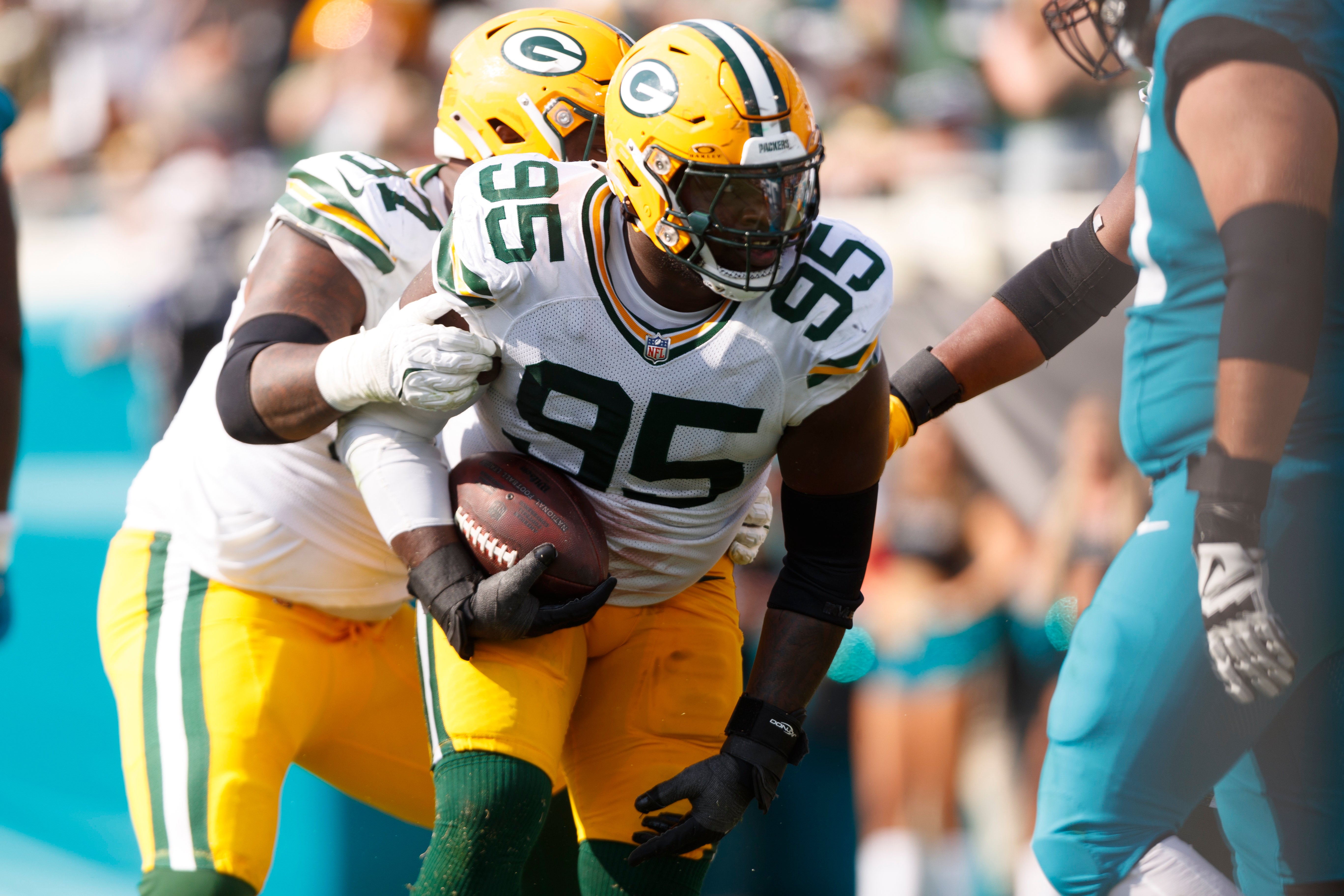 Oct 27, 2024; Jacksonville, Florida, USA; Green Bay Packers defensive lineman Devonte Wyatt (95) recovers a fumble against the Jacksonville Jaguars during the second quarter at EverBank Stadium.
