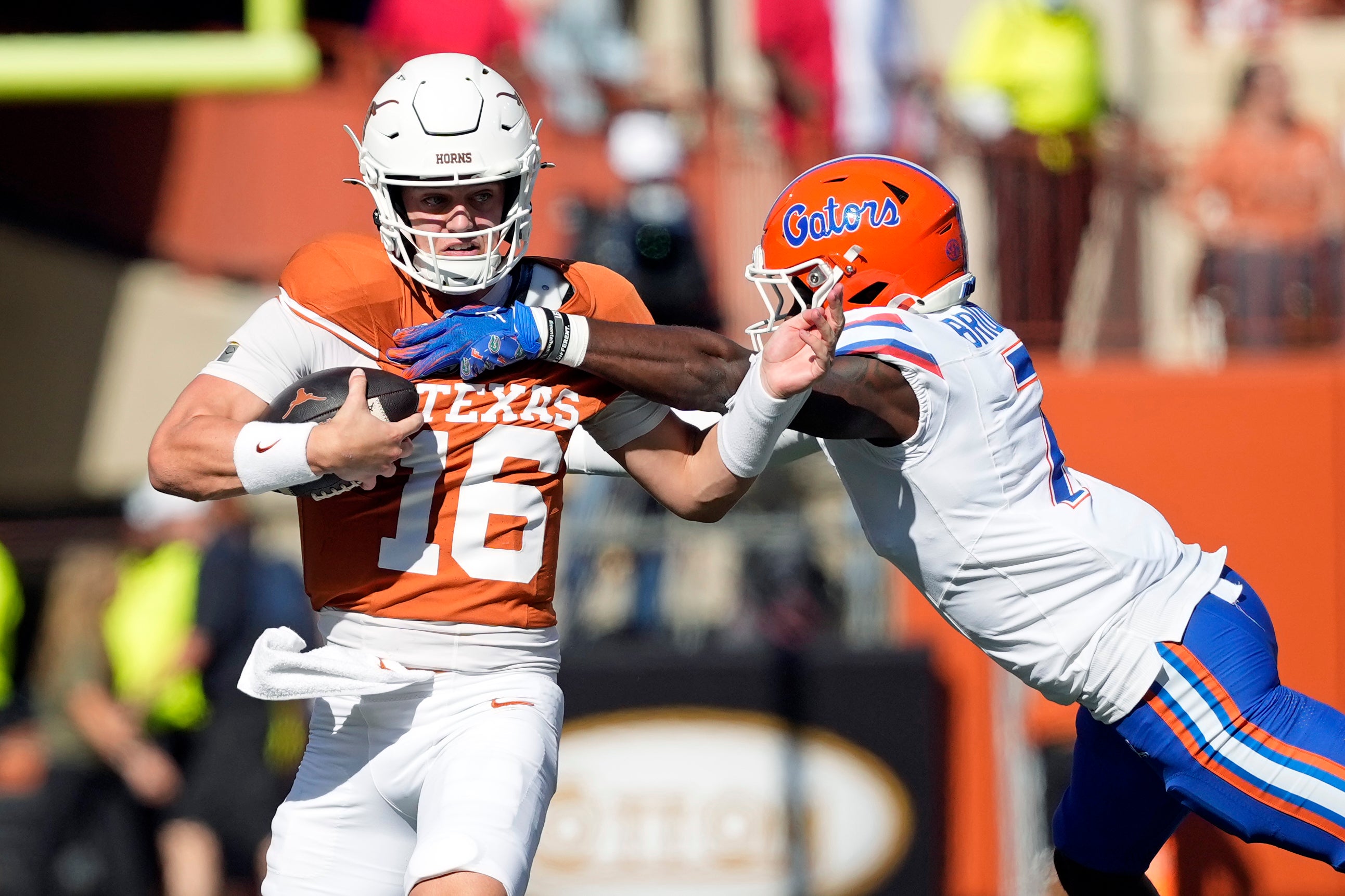 Nov 9, 2024; Austin, Texas, USA; Texas Longhorns quarterback Arch Manning (16) escapes Florida Gators defensive back Trikweze Bridges (7) while looking to pass during the second half at Darrell K Royal-Texas Memorial Stadium.