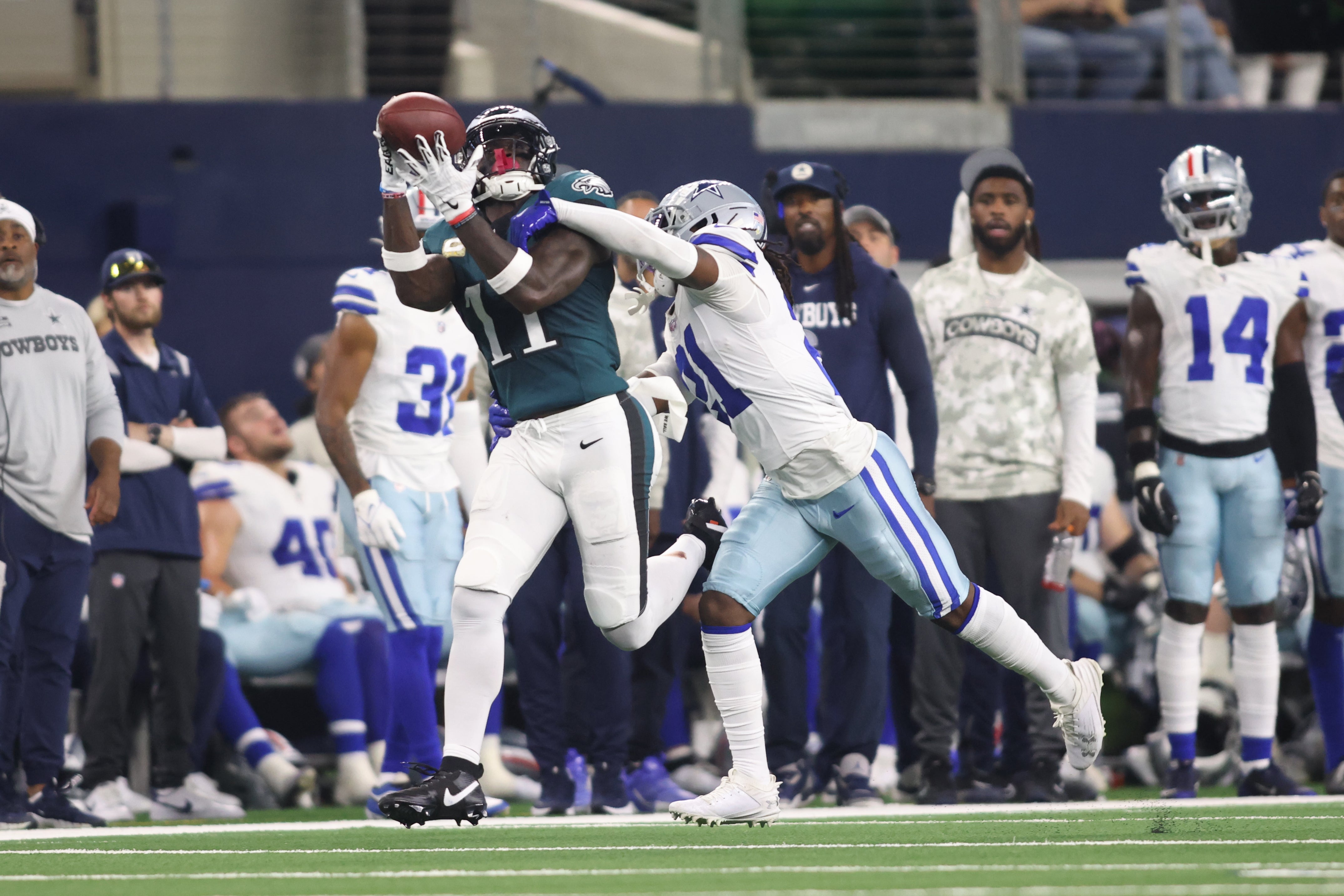 Nov 10, 2024; Arlington, Texas, USA; Philadelphia Eagles wide receiver A.J. Brown (11) catches a pass against Dallas Cowboys cornerback Caelen Carson (21) in the third quarter at AT&T Stadium.