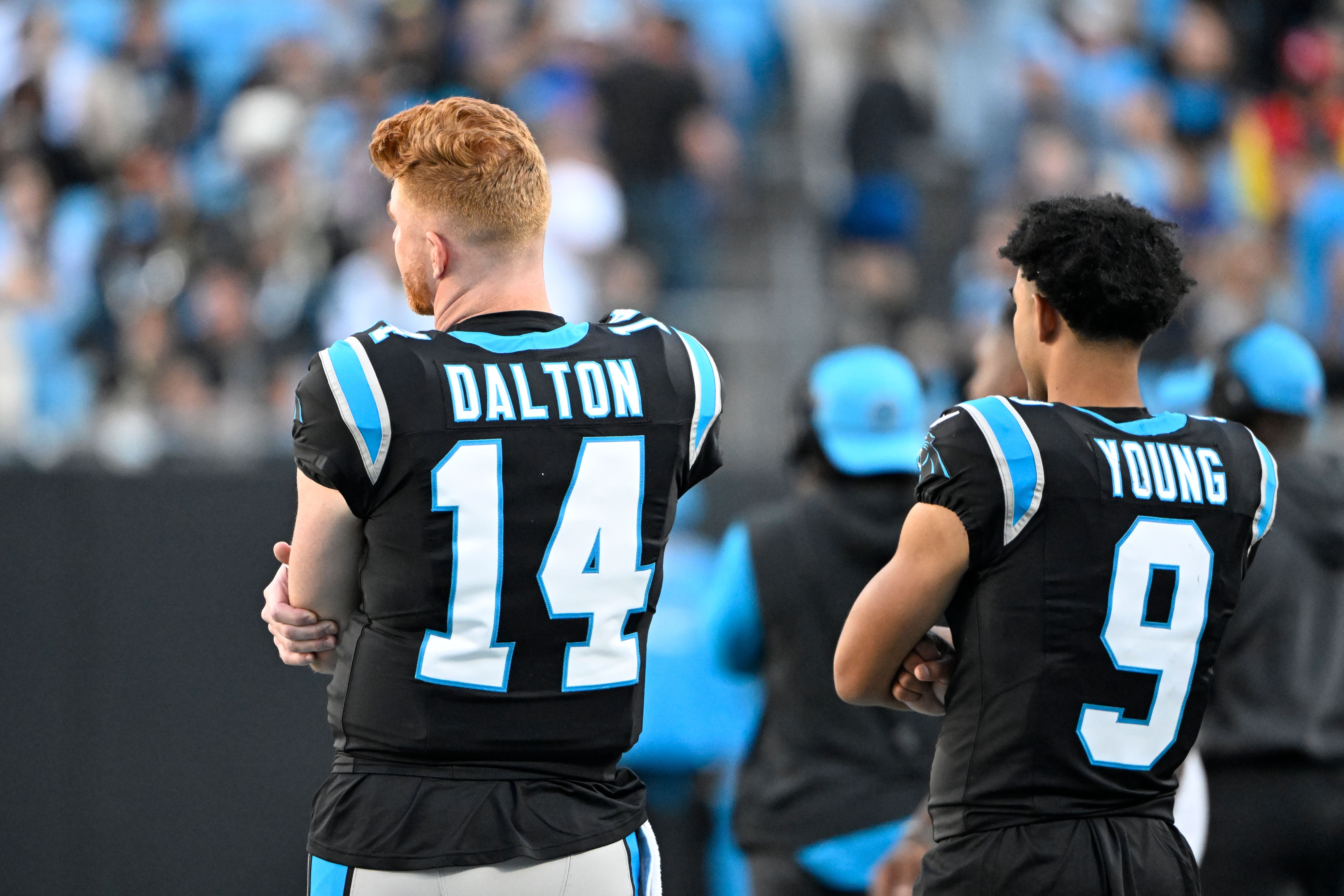 Nov 3, 2024; Charlotte, North Carolina, USA; Carolina Panthers quarterback Andy Dalton (14) and quarterback Bryce Young (9) on the sidelines in the fourth quarter at Bank of America Stadium.