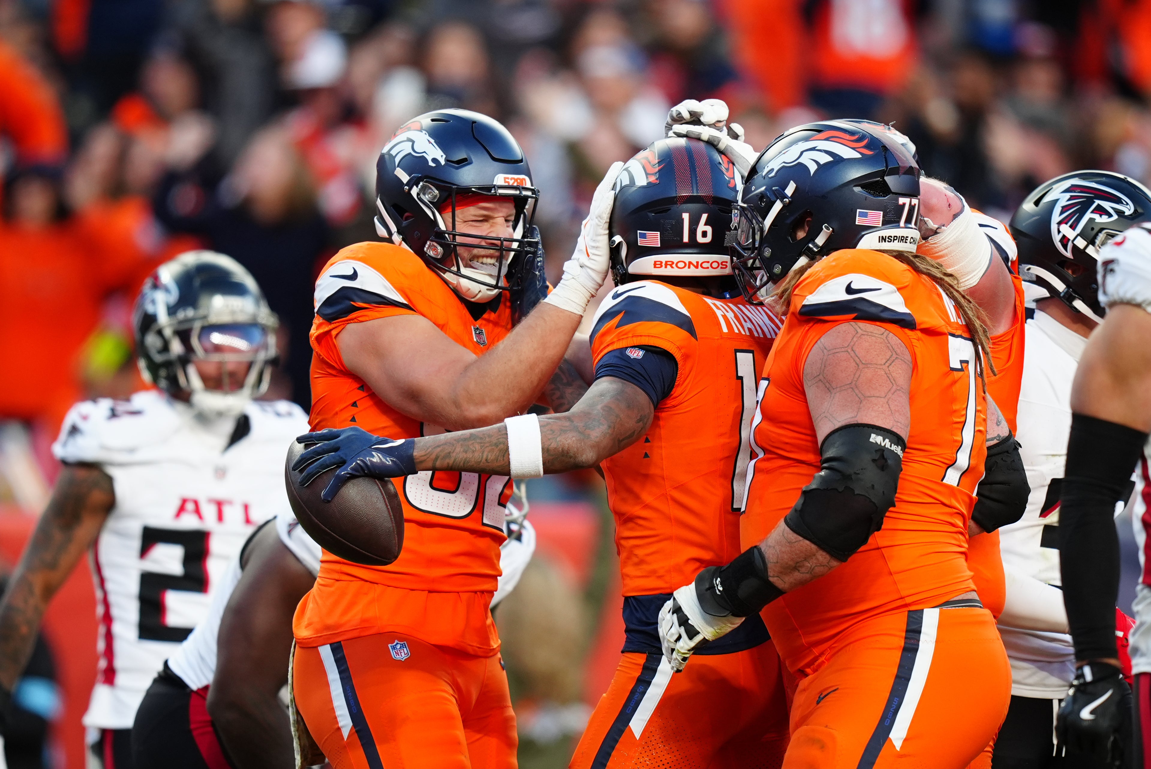 Nov 17, 2024; Denver, Colorado, USA; Denver Broncos wide receiver Troy Franklin (16) celebrates his touchdown with tight end Adam Trautman (82) and guard Quinn Meinerz (77) in the second half against the Atlanta Falcons at Empower Field at Mile High.