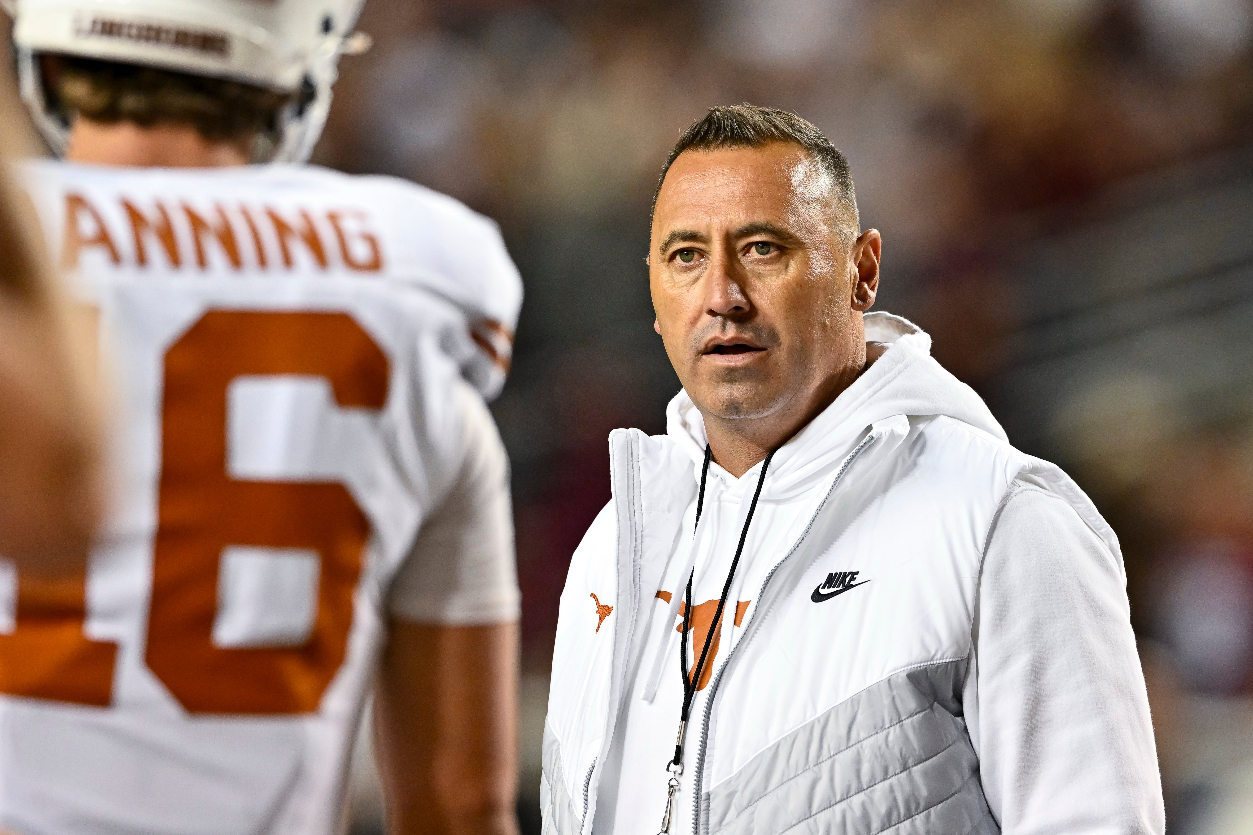 Nov 30, 2024; College Station, Texas, USA; Texas Longhorns head coach Steve Sarkisian speaks with quarterback Arch Manning (16) during warm ups against the Texas A&M Aggies at Kyle Field.