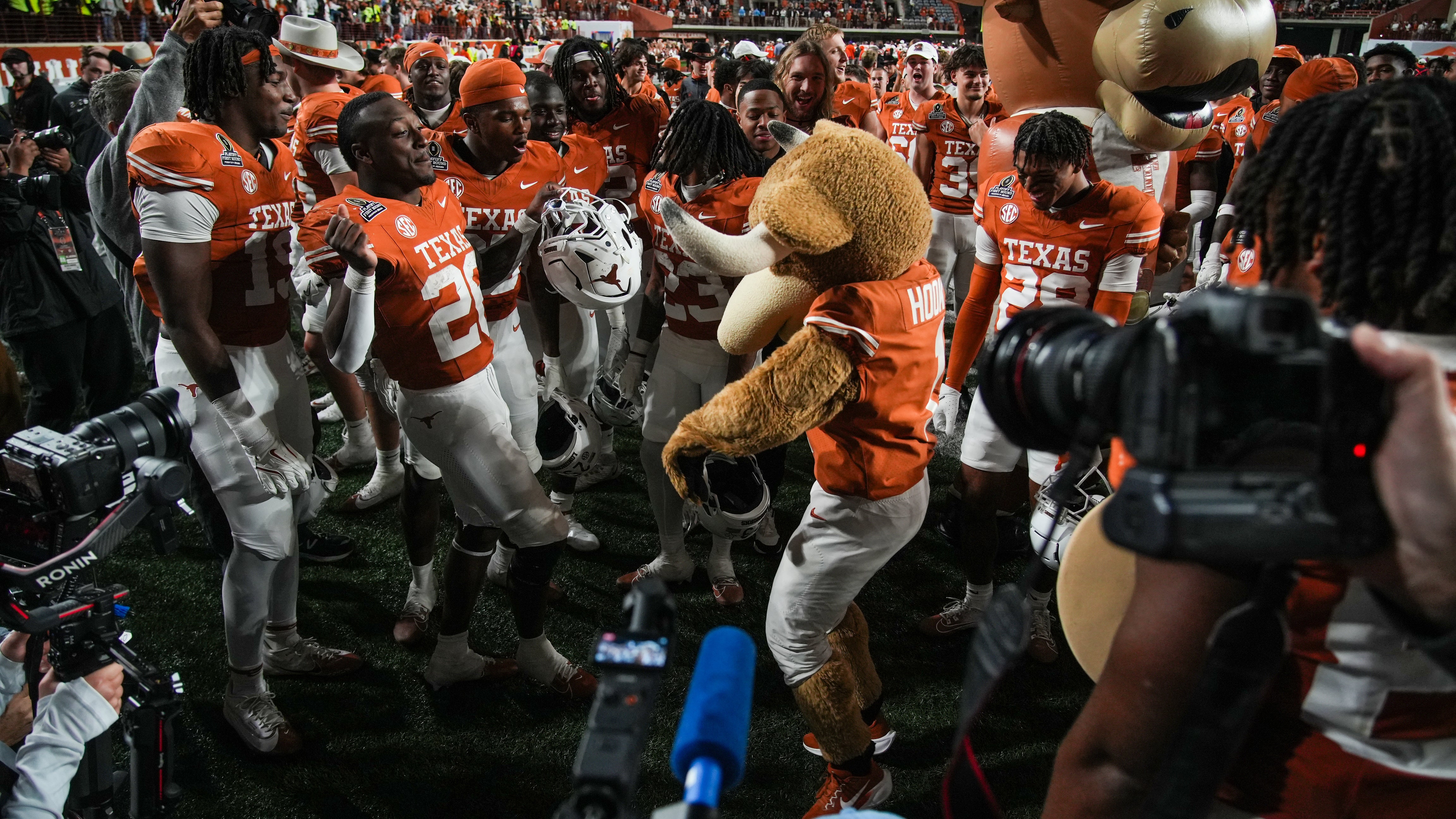 Dec 21, 2024; Austin, Texas, USA; Texas Longhorns mascot HookÕem and Texas Longhorns running back Quintrevion Wisner (26) celebrate after defeating the Clemson Tigers in the NCAA College Football Playoffs first round game at Darrell K Royal Texas Memorial Stadium.