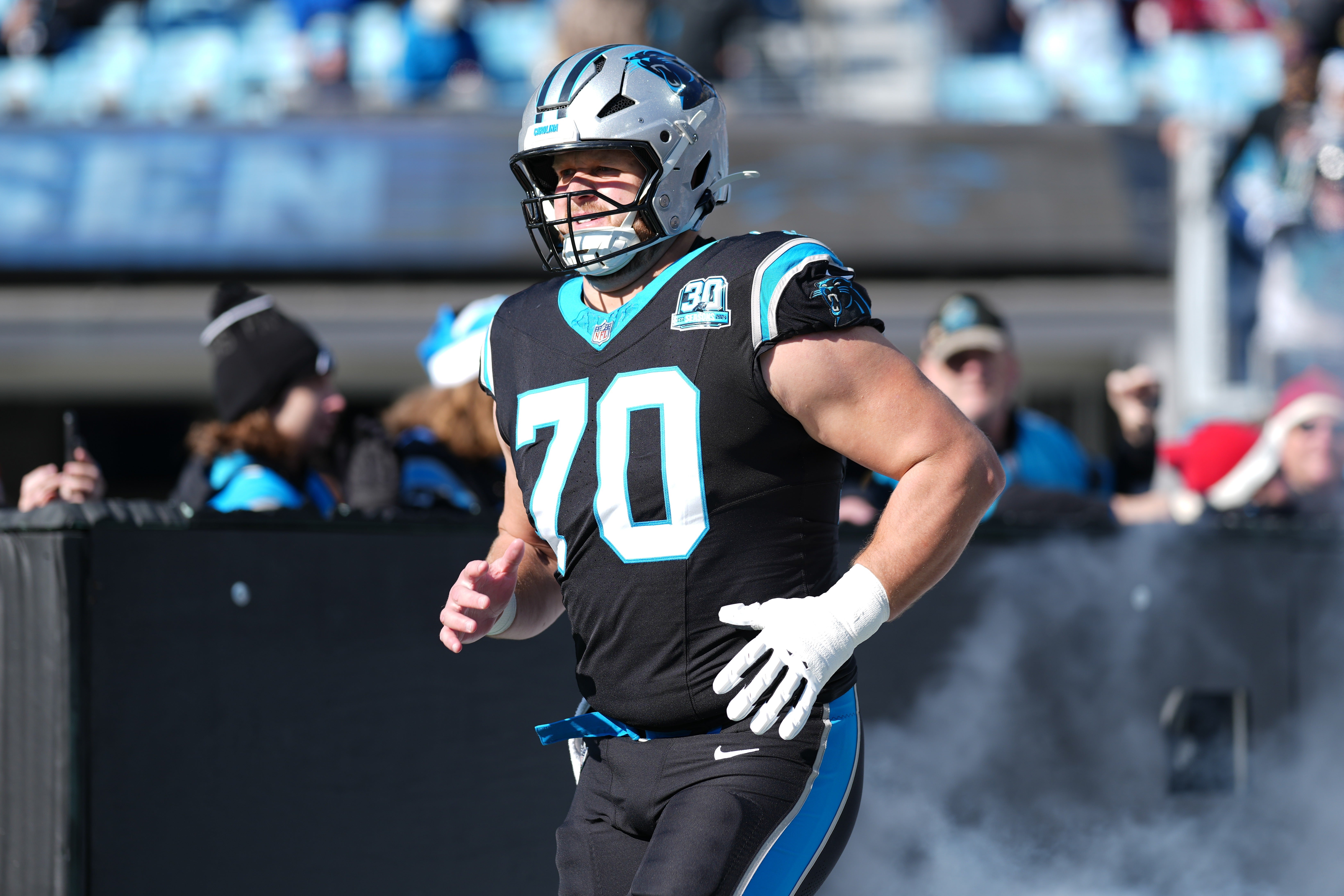 Dec 22, 2024; Charlotte, North Carolina, USA; Carolina Panthers guard Brady Christensen (70) takes the field during the first quarter against the Arizona Cardinals at Bank of America Stadium.