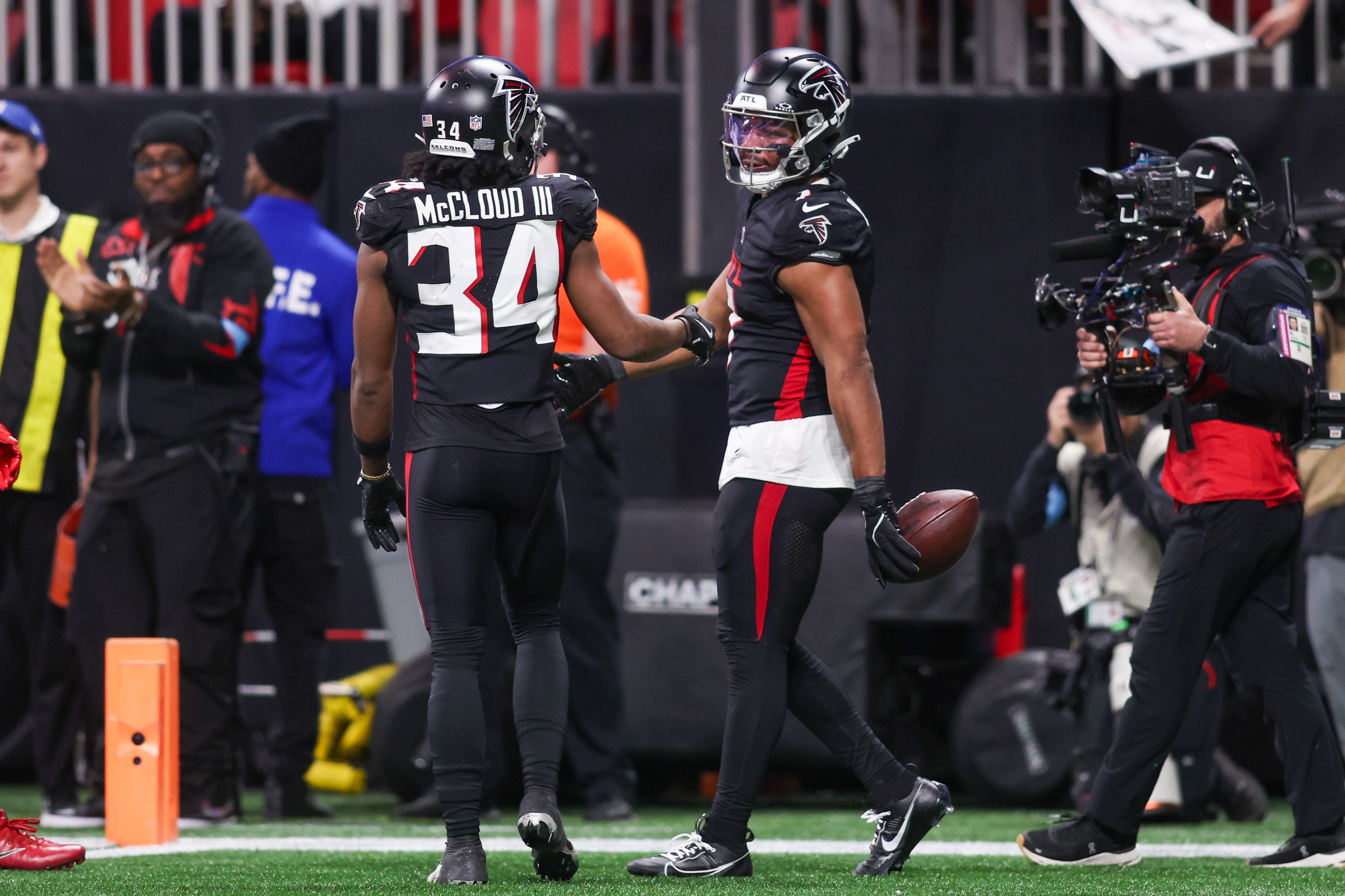 Jan 5, 2025; Atlanta, Georgia, USA; Atlanta Falcons running back Bijan Robinson (7) celebrates after a touchdown with wide receiver Ray-Ray McCloud III (34) against the Carolina Panthers in the fourth quarter at Mercedes-Benz Stadium.