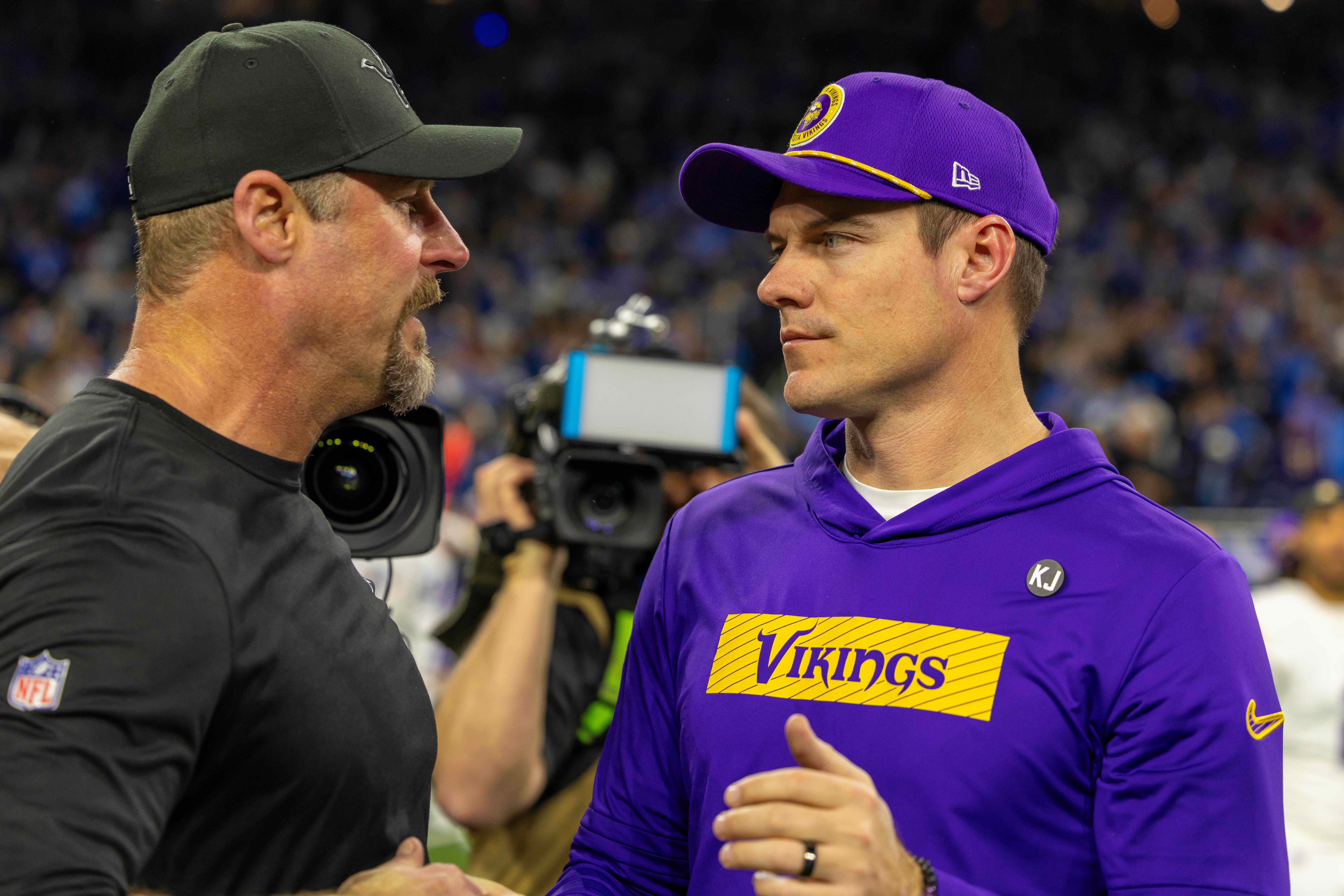 Jan 5, 2025; Detroit, Michigan, USA; Detroit Lions Head Coach Dan Campbell (L) shakes hands with Minnesota Vikings Head Coach Sean McDermott after the game at Ford Field.