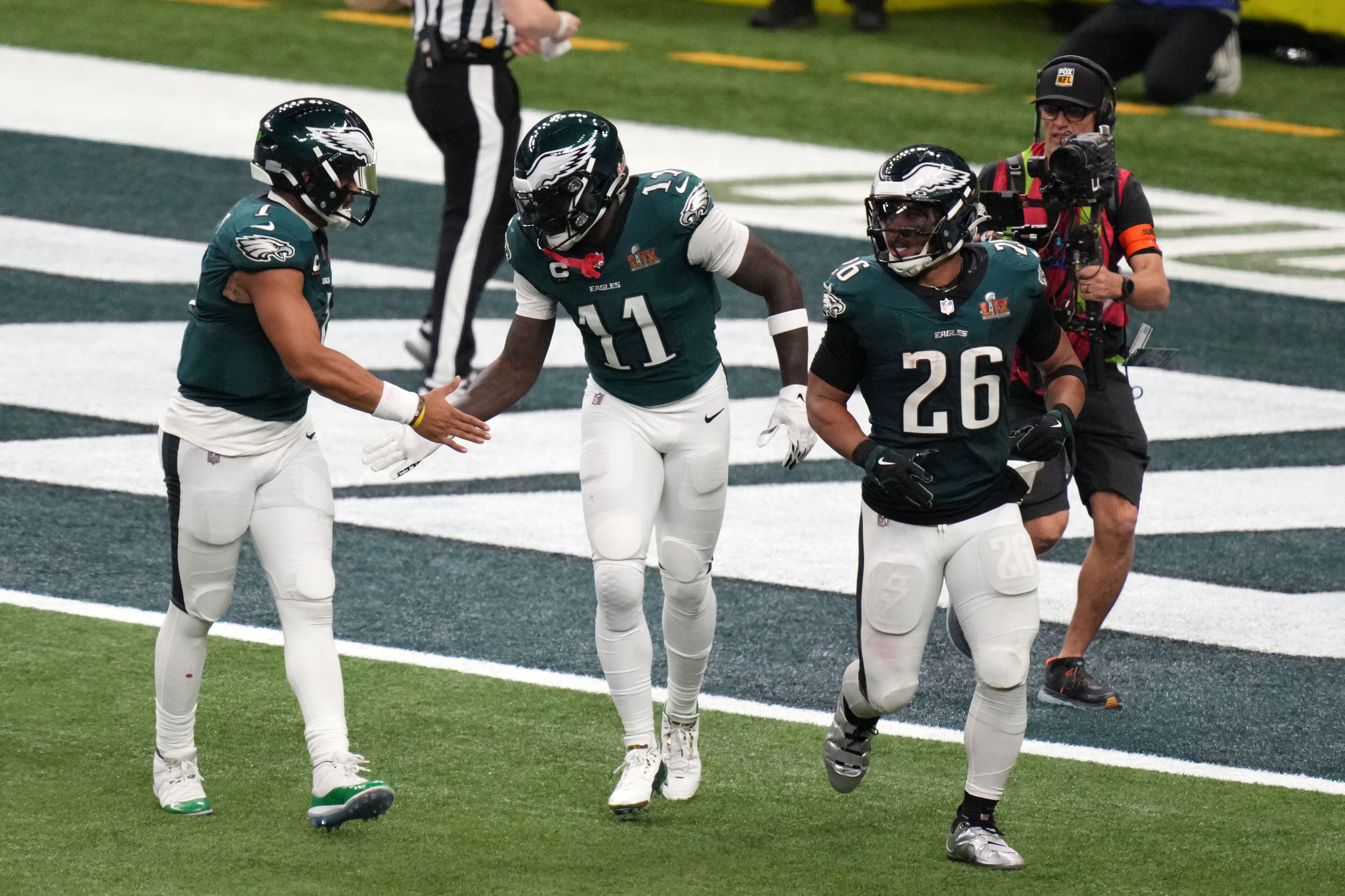 Philadelphia Eagles wide receiver A.J. Brown (11) reacts with quarterback Jalen Hurts (1) after making a touchdown catch against the Kansas City Chiefs during the second quarter in Super Bowl LIX at C...