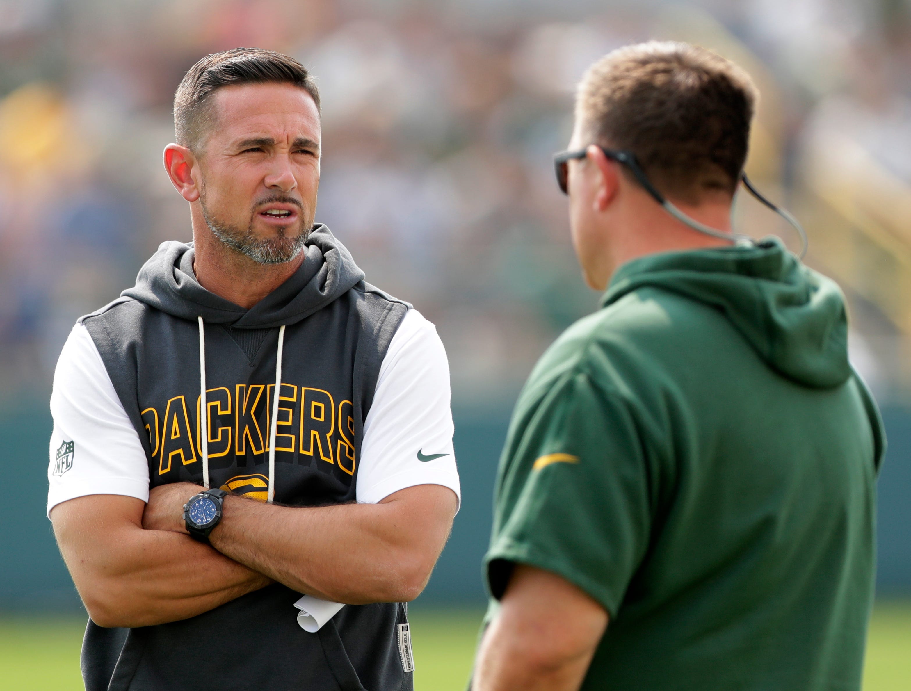 Green Bay Packers Coach Matt LaFleur, left, talks with General Manager Brian Gutekunst during practice on July 25, 2025, at Ray Nitschke Field in Ashwaubenon, Wis.