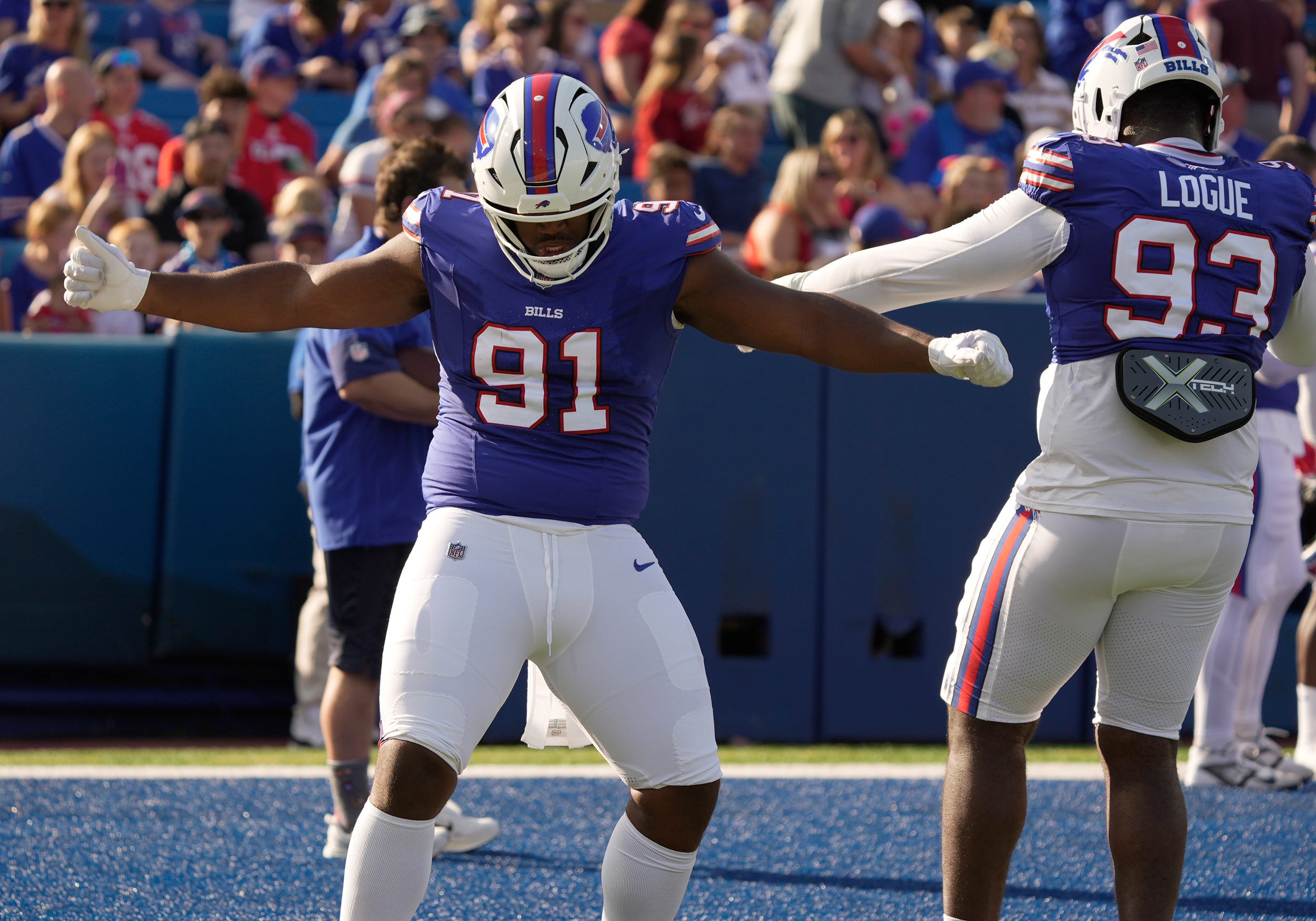 Buffalo Bills defensive tackle Ed Oliver and defensive tackle Zion Logue dance to the music for a few moments while waiting for their turn to run a drill during the Return of the Blue & Red practice at Highmark Stadium in Orchard Park on Aug.1, 2025.