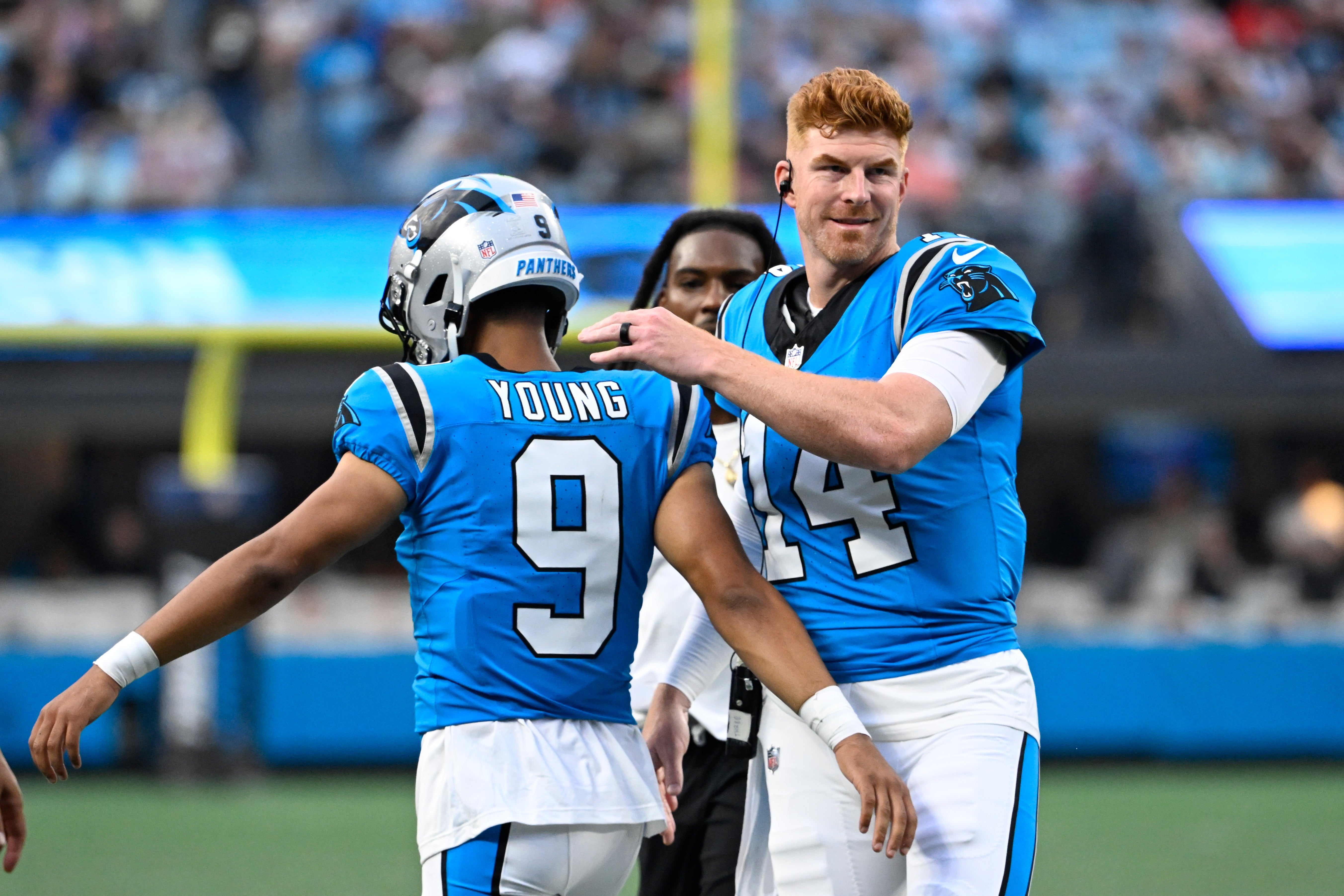 Aug 8, 2025; Charlotte, North Carolina, USA; Carolina Panthers quarterback Bryce Young (9) with quarterback Andy Dalton (14) in the first quarter at Bank of America Stadium.