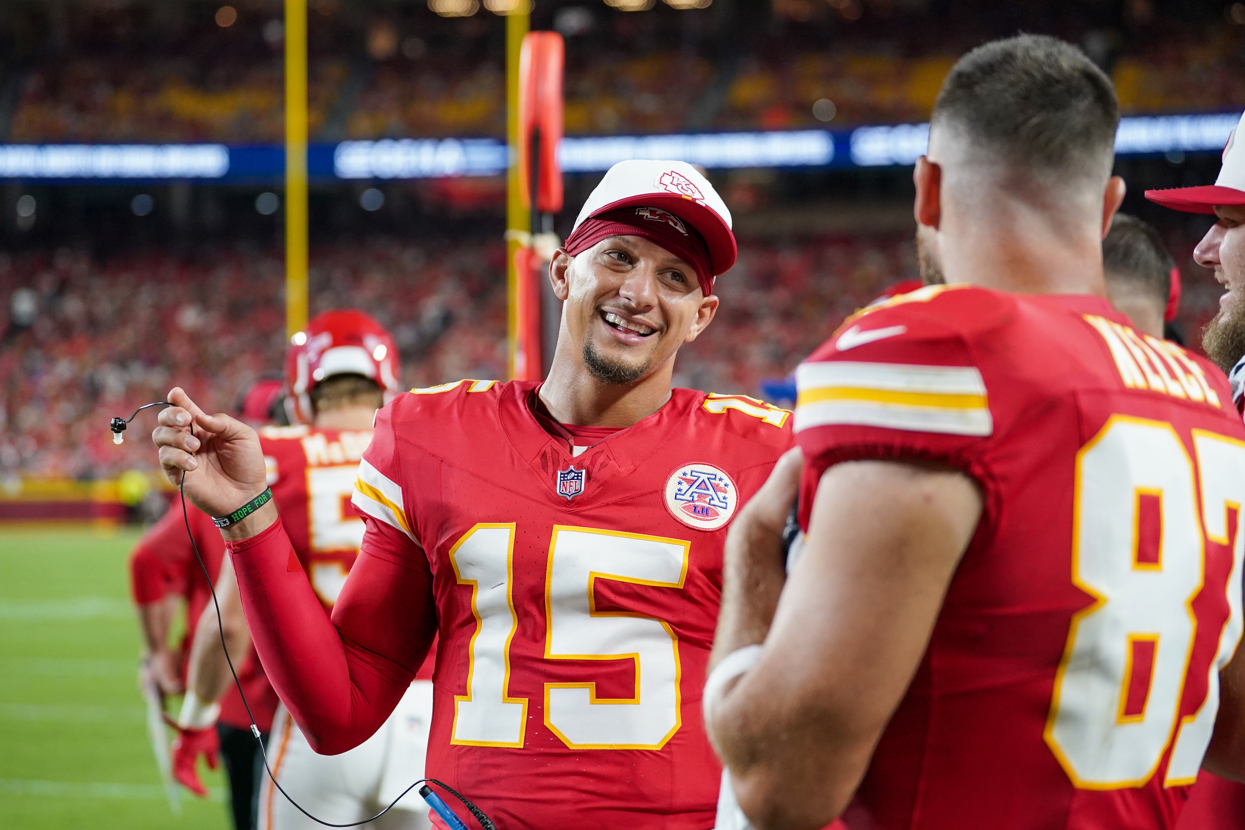 Kansas City Chiefs quarterback Patrick Mahomes (15) talks with tight end Travis Kelce (87) on the sidelines
