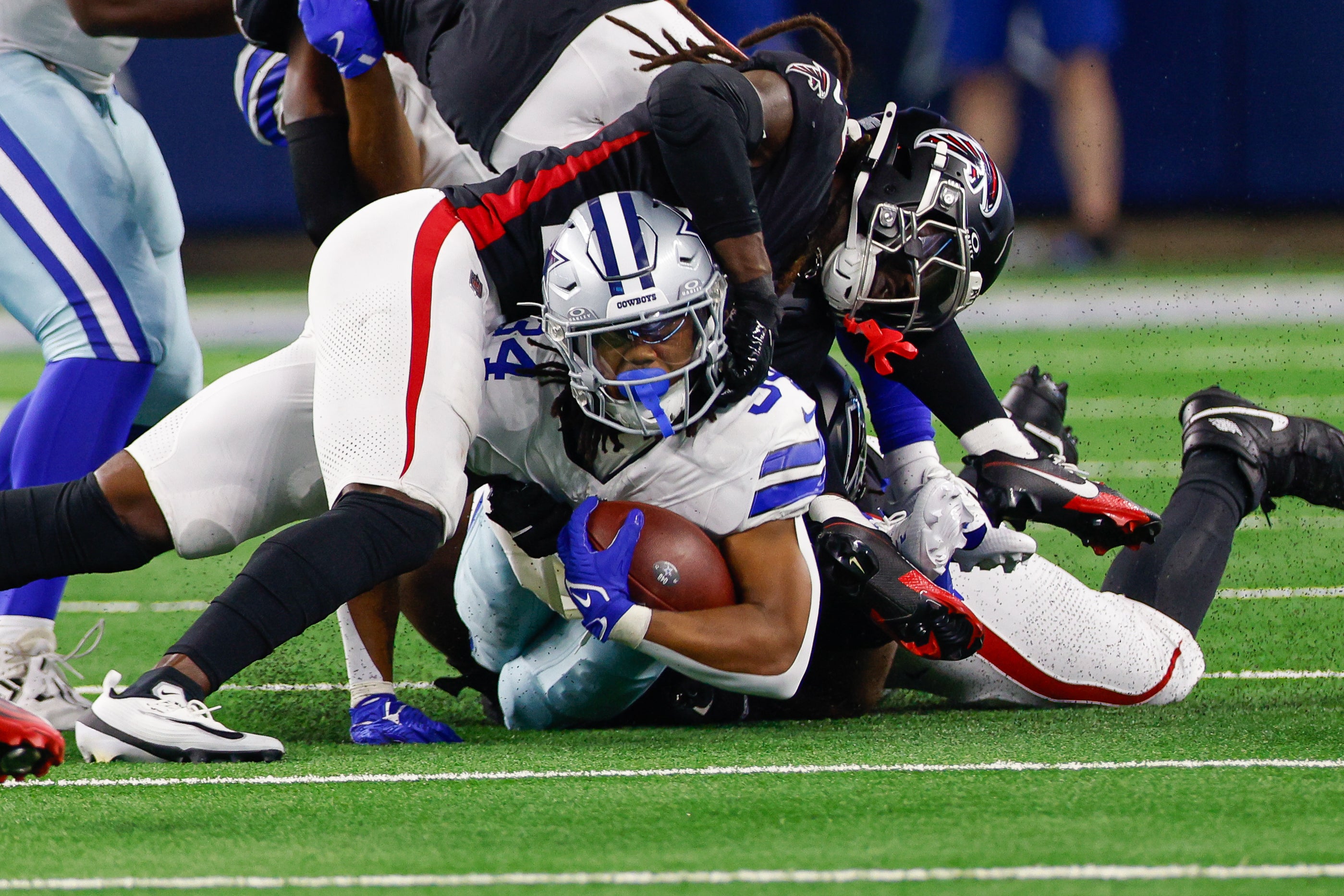 Aug 22, 2025; Arlington, Texas, USA; Dallas Cowboys running back Jaydon Blue (34) is tackled by the Atlanta Falcons during the fourth quarter at AT&T Stadium.
