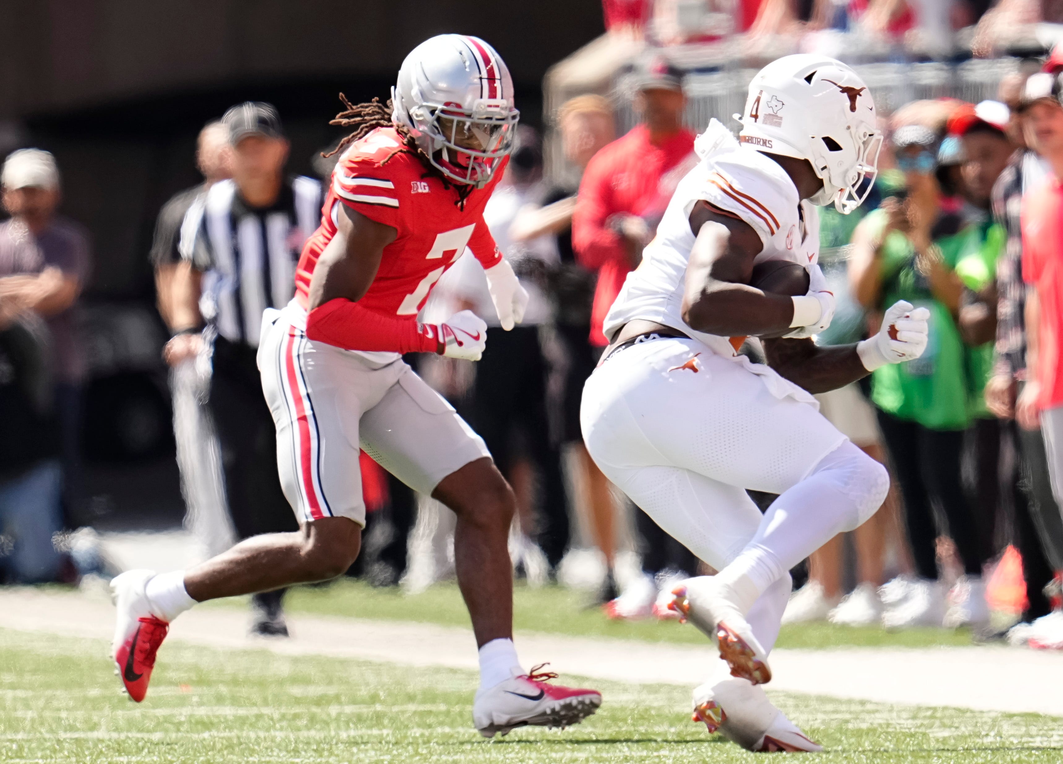 Ohio State Buckeyes cornerback Jermaine Mathews Jr. (7) pursues Texas Longhorns running back CJ Baxter (4) during the NCAA football game at Ohio Stadium on Aug. 30, 2025.