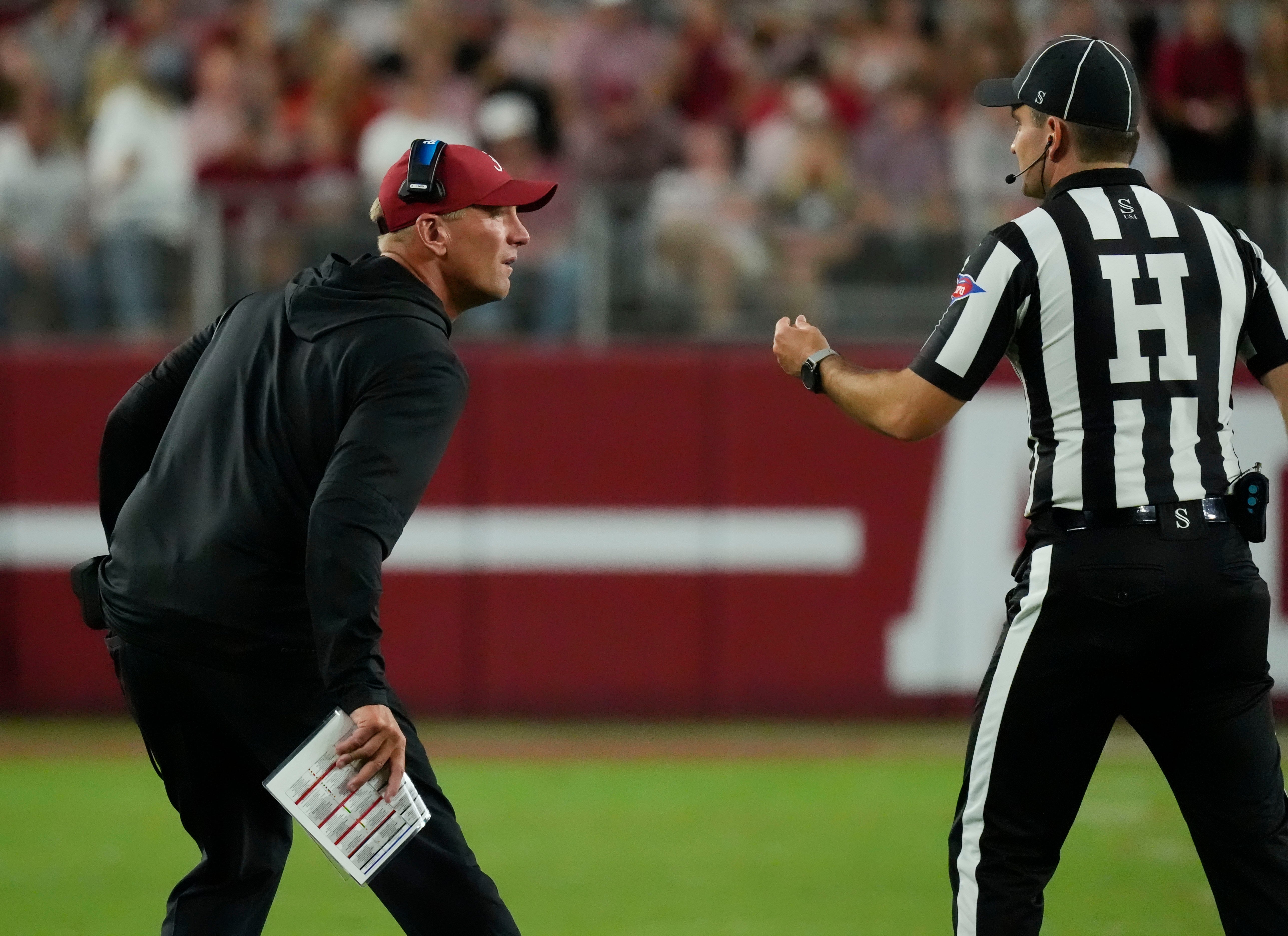 Sep 6, 2025; Tuscaloosa, Alabama, USA; Alabama head coach Kalen DeBoer gets the penalty on his offense from an official during the game with UL Monroe at Saban Field at Bryant-Denny Stadium.
