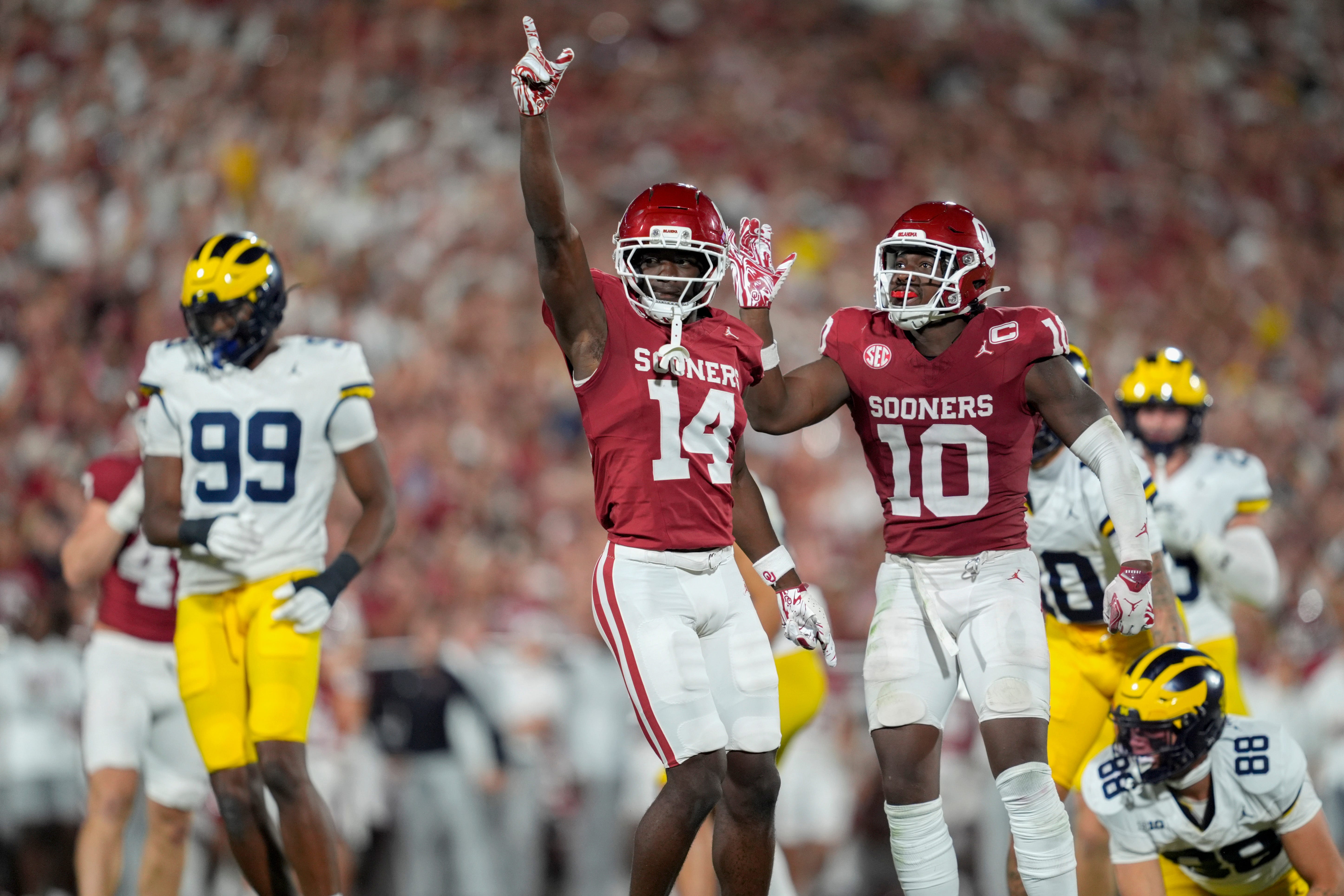 Oklahoma Sooners wide receiver Elijah Thomas (14) and linebacker Kip Lewis (10) celebrate during a college football game between the University of Oklahoma Sooners (OU) and the University of Michigan Wolverines at Gaylord Family Ð Oklahoma Memorial Stadium in Norman, Okla., Saturday, Sept. 6, 2025. Oklahoma won 24-13.