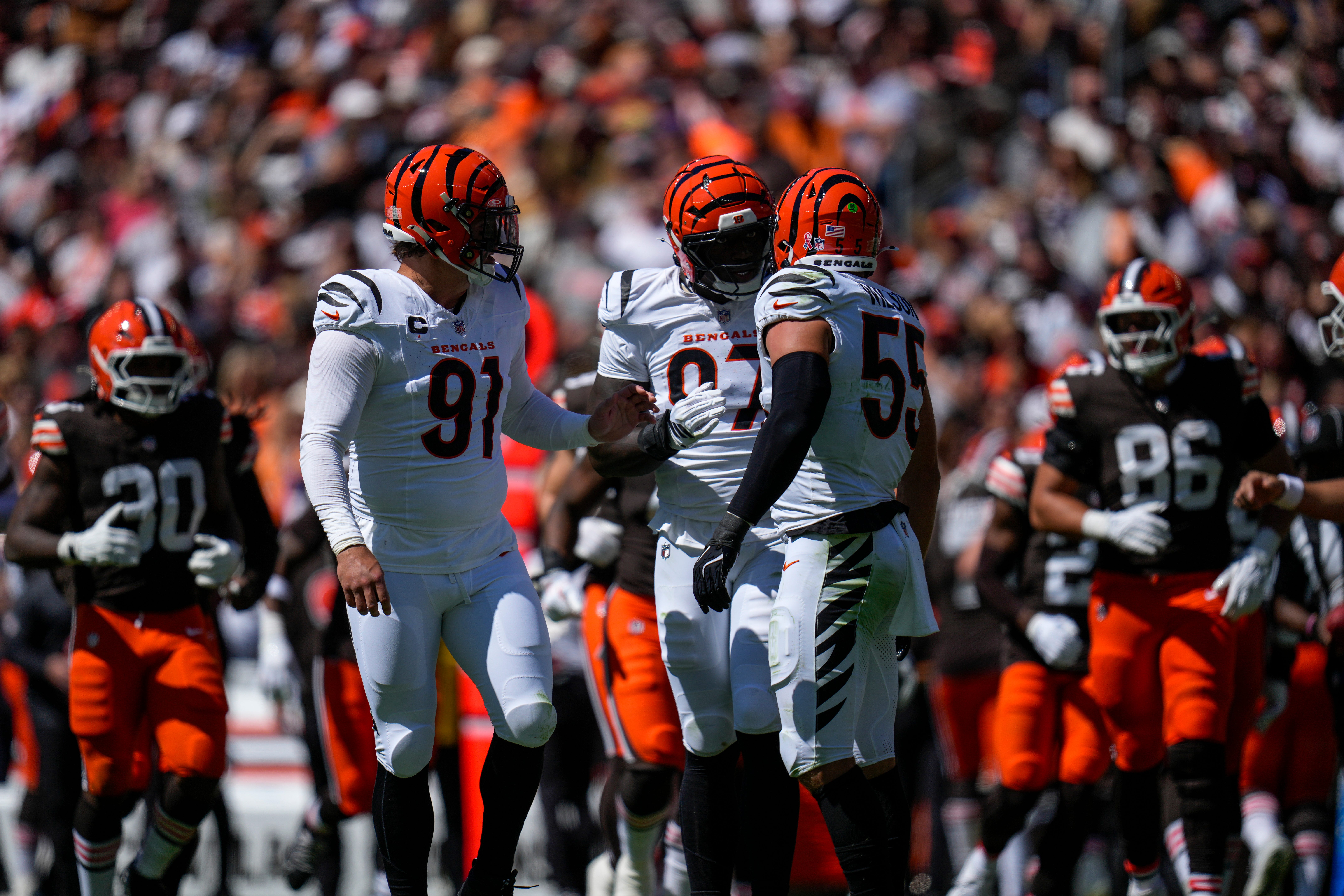 Cincinnati Bengals defensive end Trey Hendrickson (91), defensive end Shemar Stewart (97) and linebacker Logan Wilson (55) talk before coming off the field on fourth down in the second quarter of the NFL Week 1 game between the Cleveland Browns and the Cincinnati Bengals at Huntington Bank Field in Cleveland on Sunday, Sept. 7, 2025.