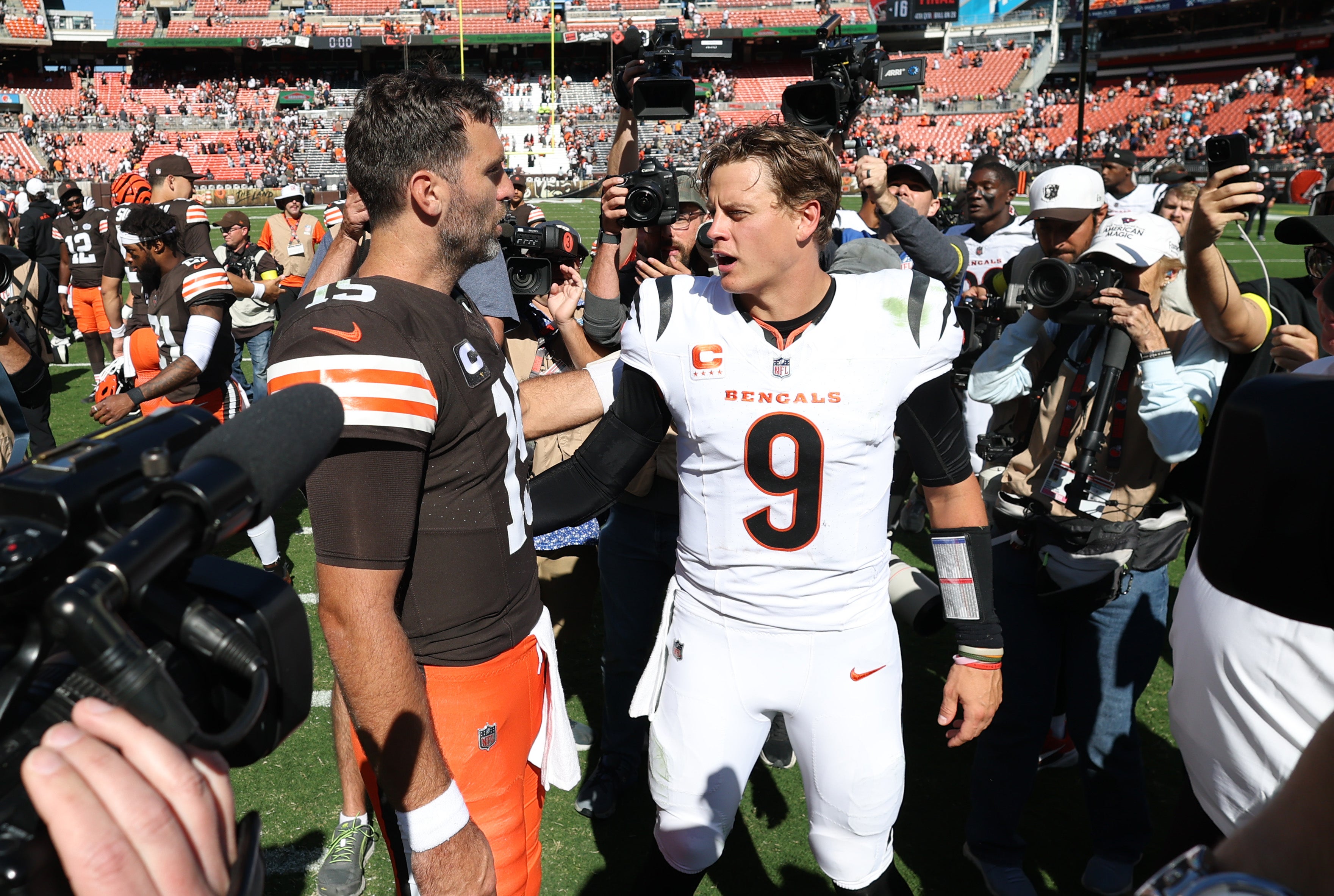 Sep 7, 2025; Cleveland, Ohio, USA; Cleveland Browns quarterback Joe Flacco (15) and Cincinnati Bengals quarterback Joe Burrow (9) greet each other after a game at Huntington Bank Field.