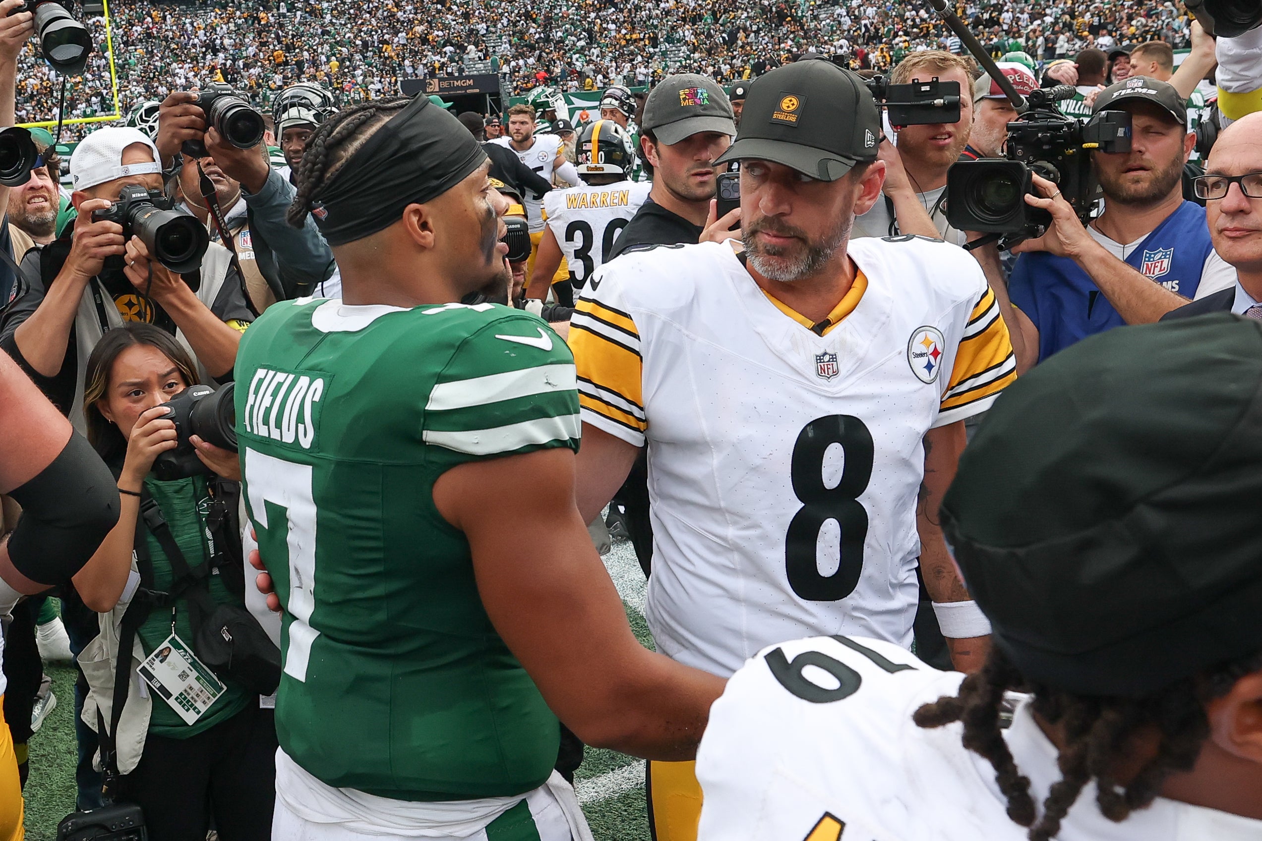 Sep 7, 2025; East Rutherford, New Jersey, USA; New York Jets quarterback Justin Fields (7) greets Pittsburgh Steelers quarterback Aaron Rodgers (8) after the game at MetLife Stadium.