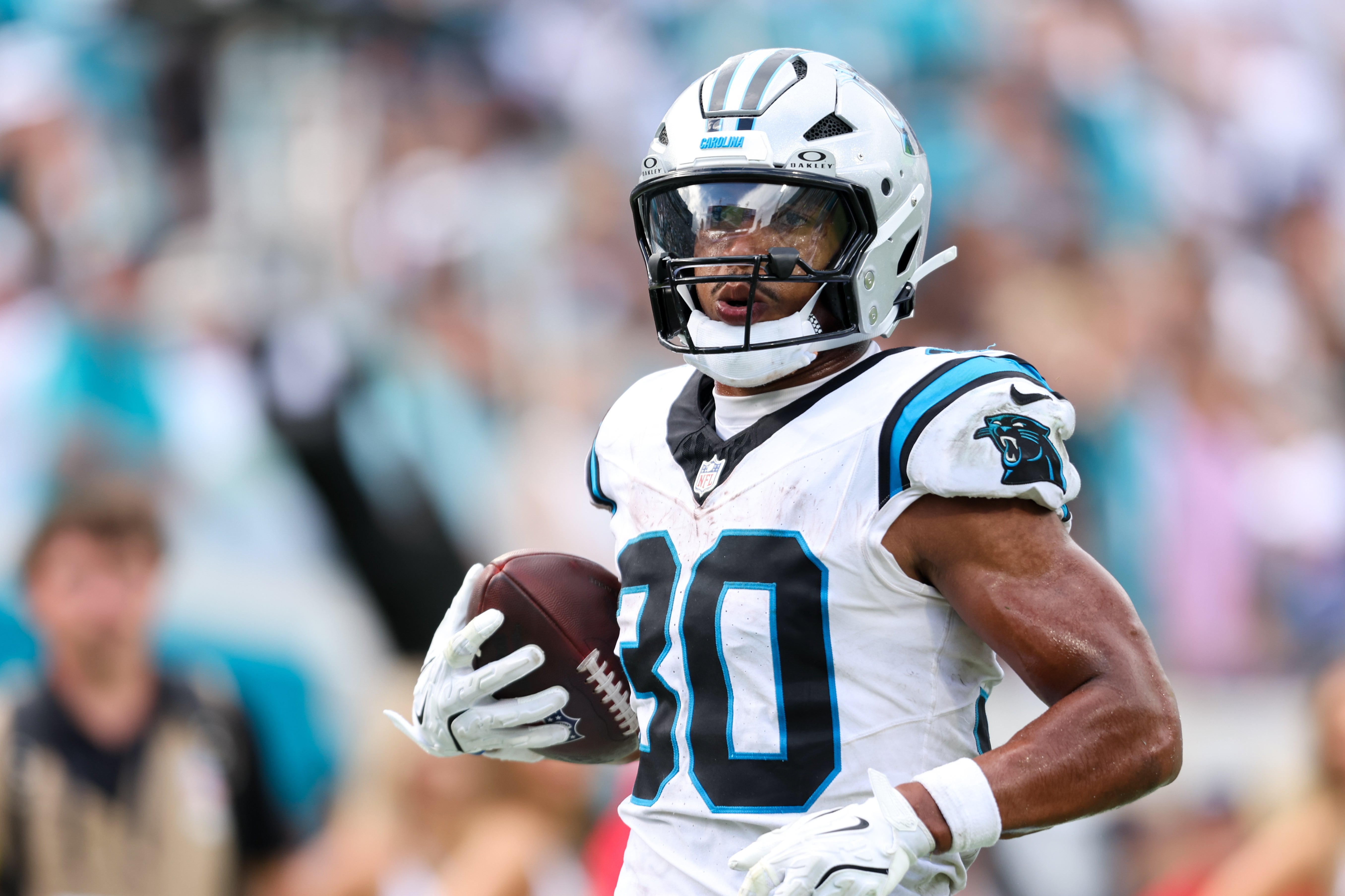 Sep 7, 2025; Jacksonville, Florida, USA; Carolina Panthers running back Chuba Hubbard (30) runs after the catch 27-yard touchdown reception during the second half against the Jacksonville Jaguars at EverBank Stadium.