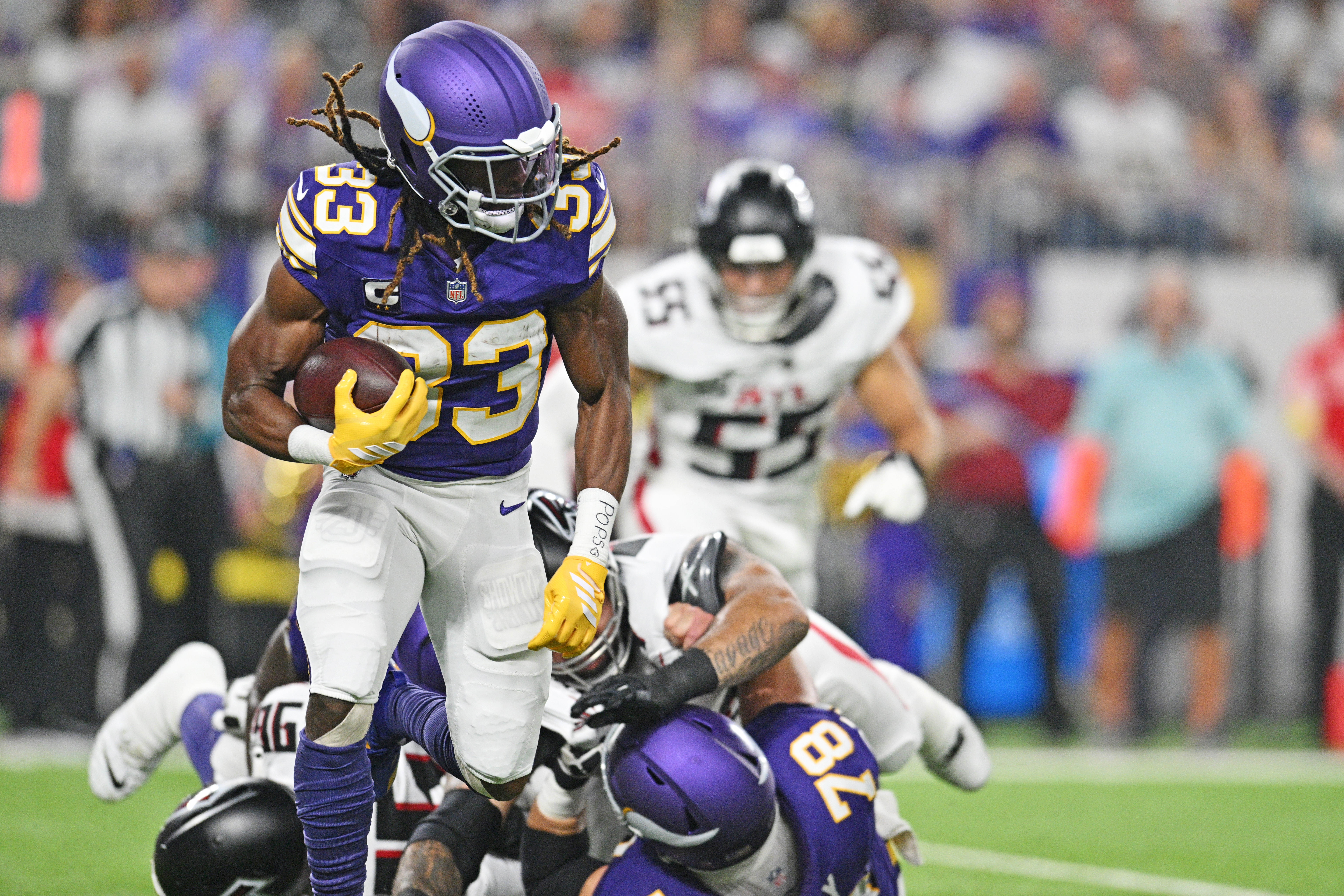 Sep 14, 2025; Minneapolis, Minnesota, USA; Minnesota Vikings running back Aaron Jones Sr. (33) runs the ball during the first half against the Atlanta Falcons at U.S. Bank Stadium.
