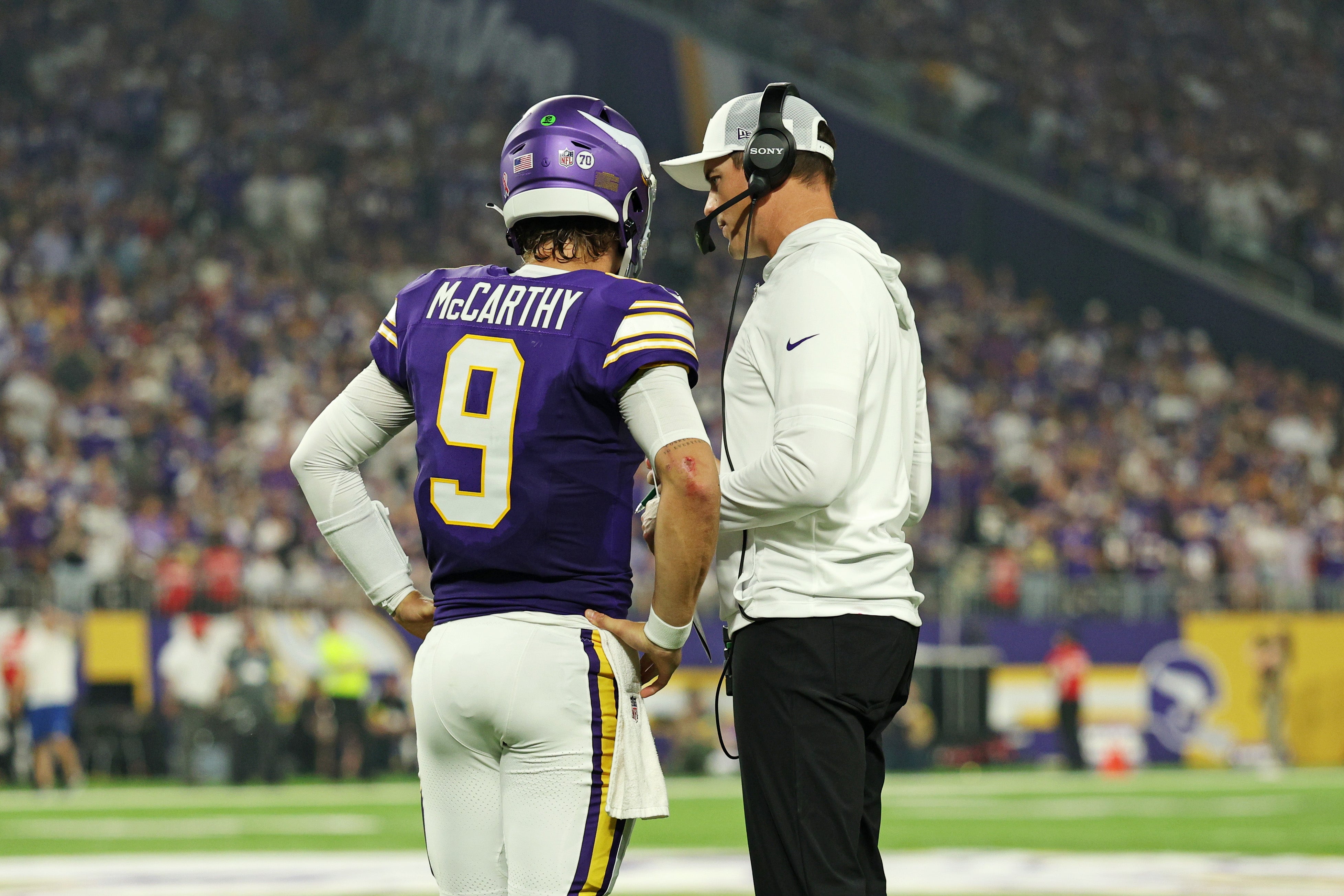 Sep 14, 2025; Minneapolis, Minnesota, USA; Minnesota Vikings quarterback J.J. McCarthy (9) speaks with Minnesota Vikings head coach Kevin O'Connell during the first half against the Atlanta Falcons at U.S. Bank Stadium.
