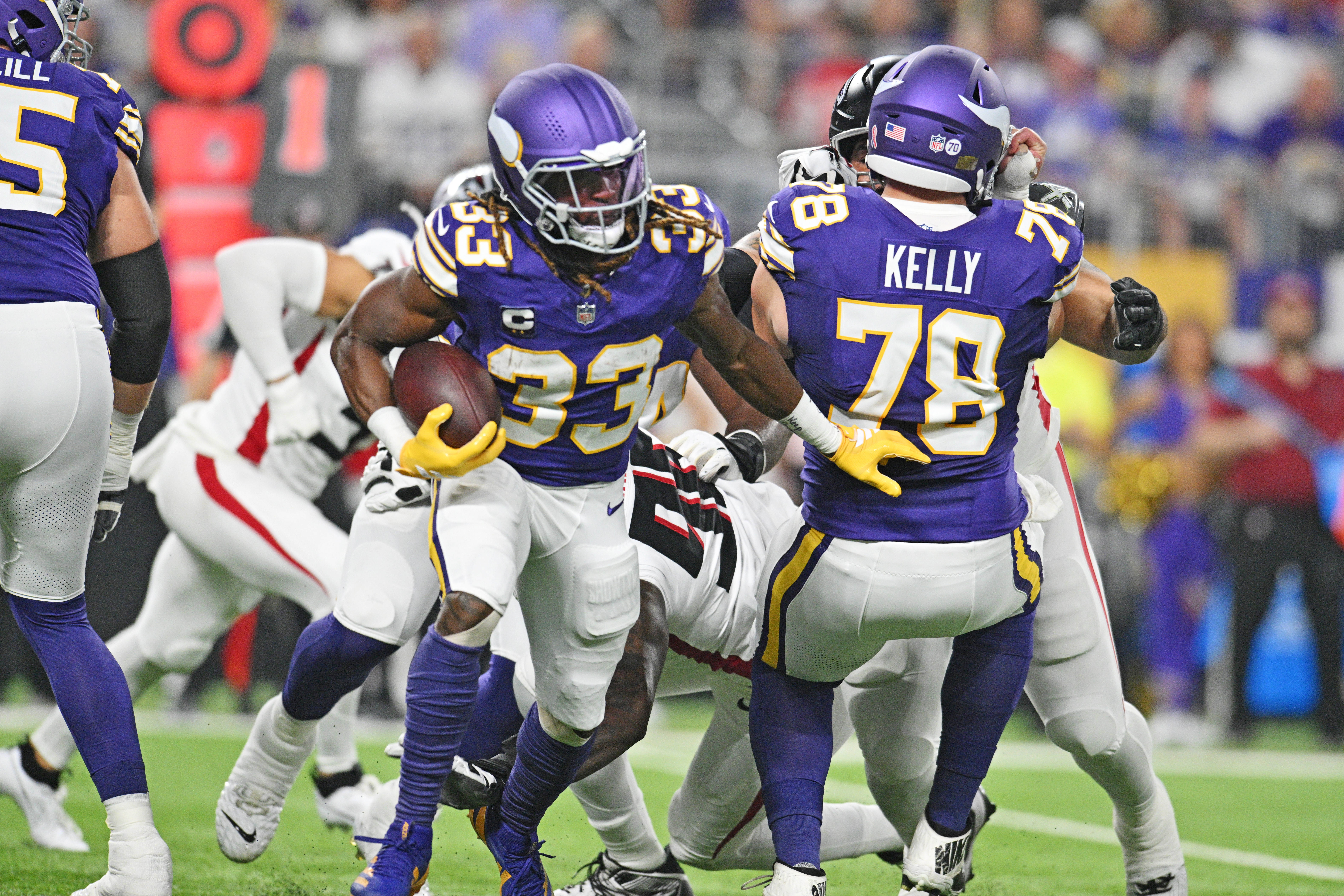 Sep 14, 2025; Minneapolis, Minnesota, USA; Minnesota Vikings running back Aaron Jones Sr. (33) runs the ball during the first half against the Atlanta Falcons at U.S. Bank Stadium.